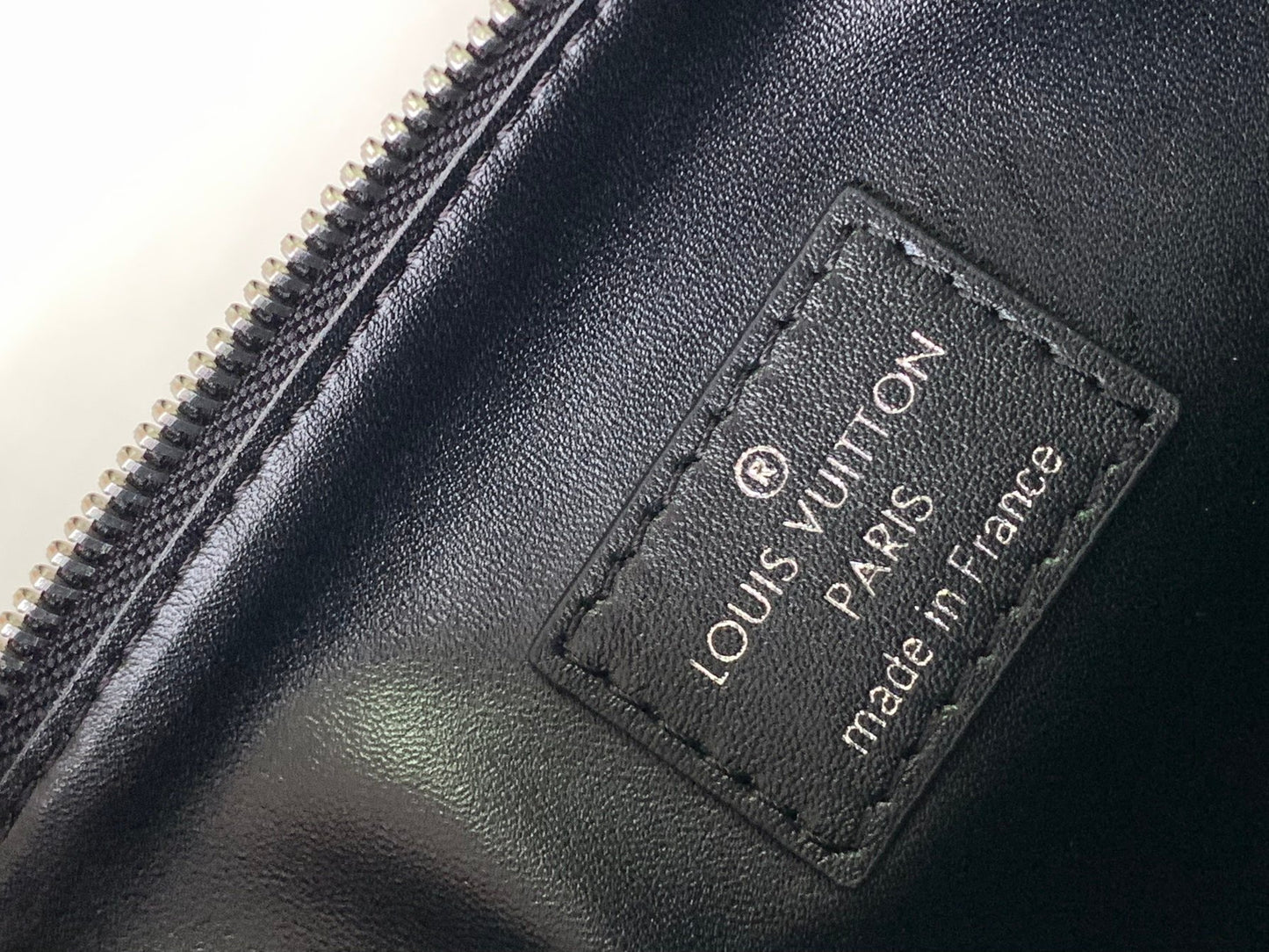 Black Embossed Monogram Crossbody Bag with Chain Detail and Wide Adjustable Strap