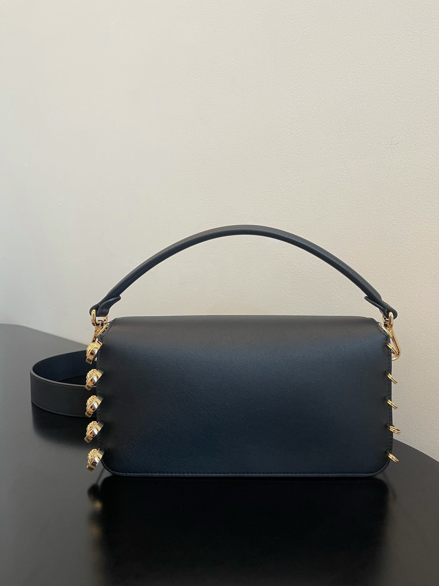 Black Leather Shoulder Bag with Gold Safety Pin Detail & Studded Accents