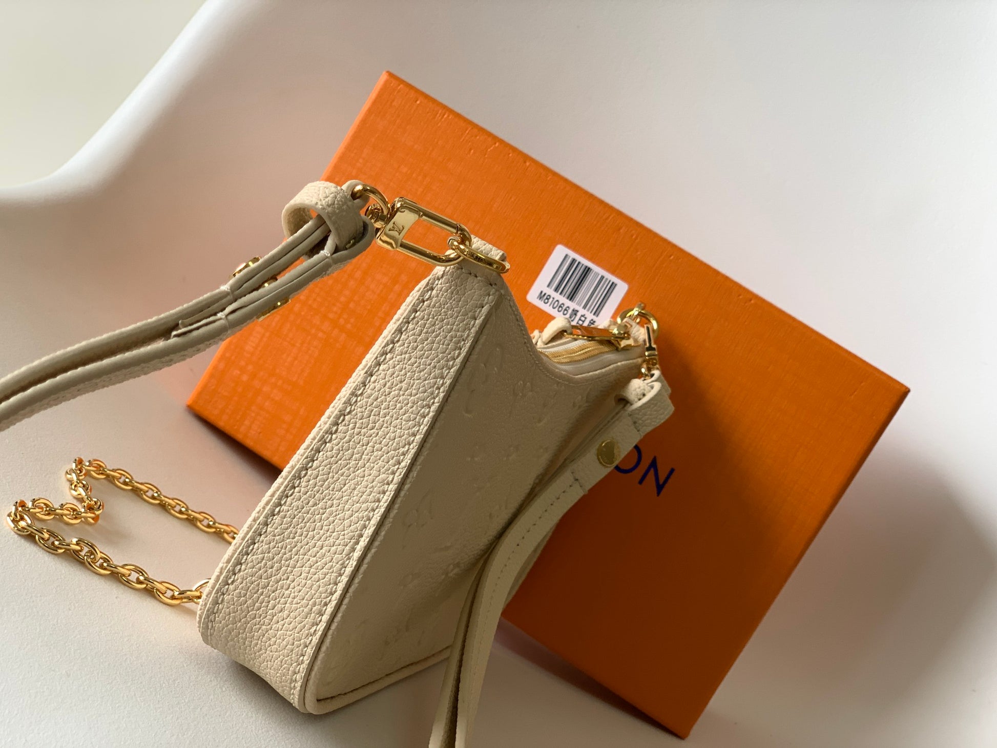 Louis Vuitton Elegant Cream Embossed Vegan Leather Underarm Bag with Gold Chain