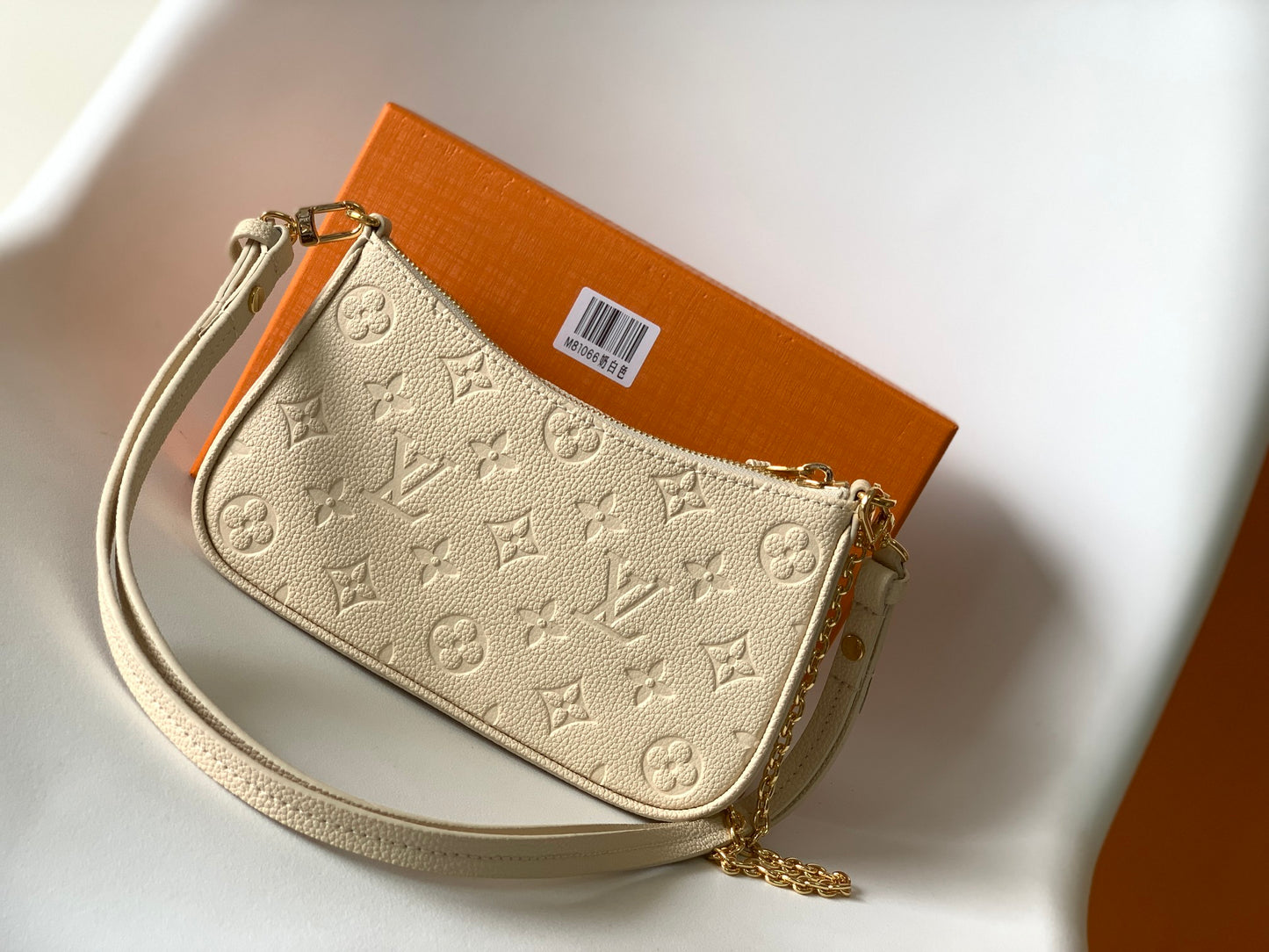 Louis Vuitton Elegant Cream Embossed Vegan Leather Underarm Bag with Gold Chain