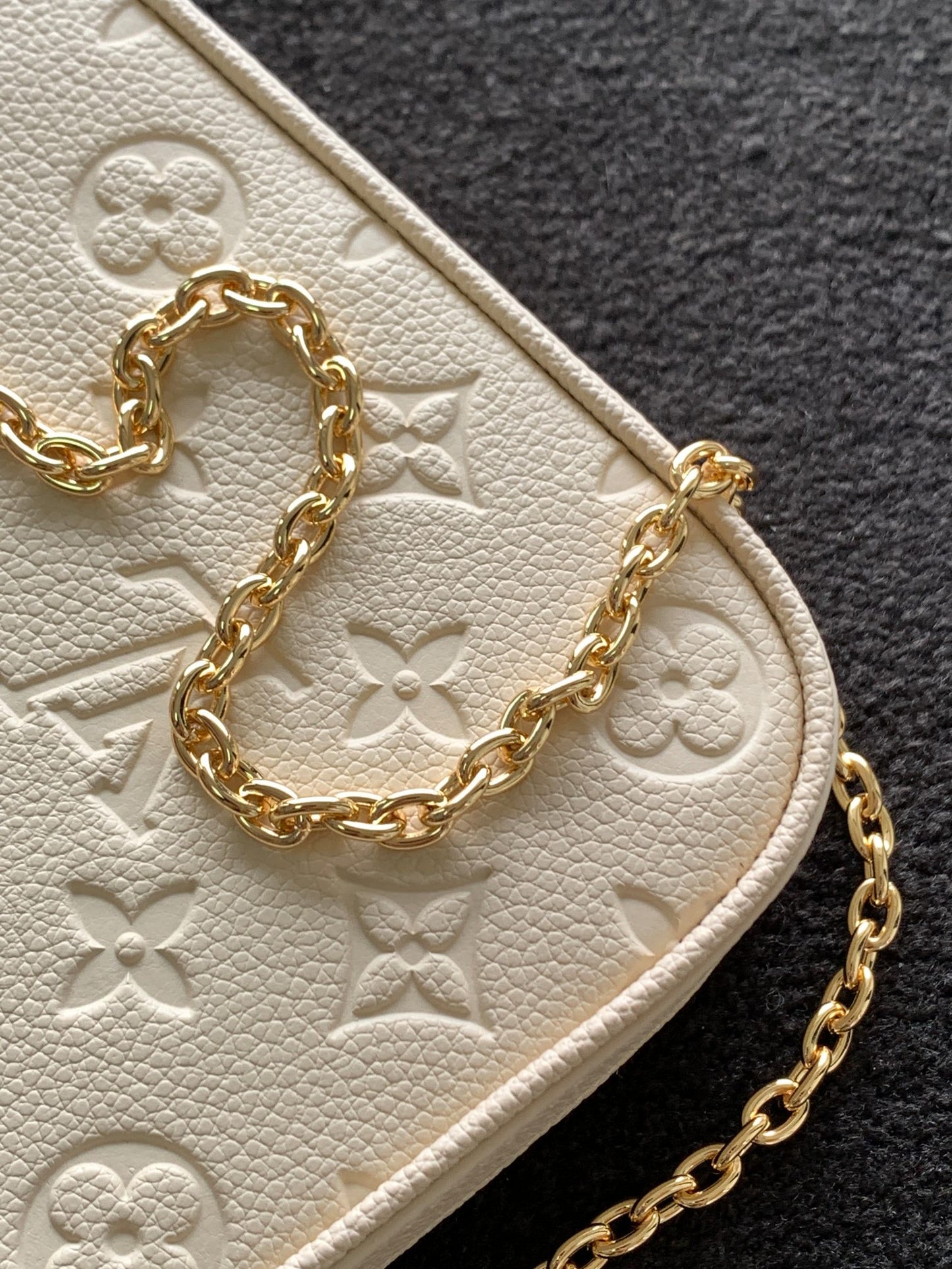 Louis Vuitton Elegant Cream Embossed Vegan Leather Underarm Bag with Gold Chain