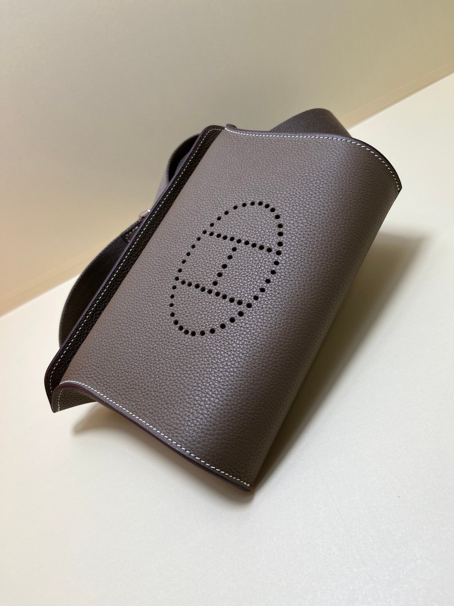 Luxury Pebbled Leather Crossbody Bag with Perforated H Logo - Taupe