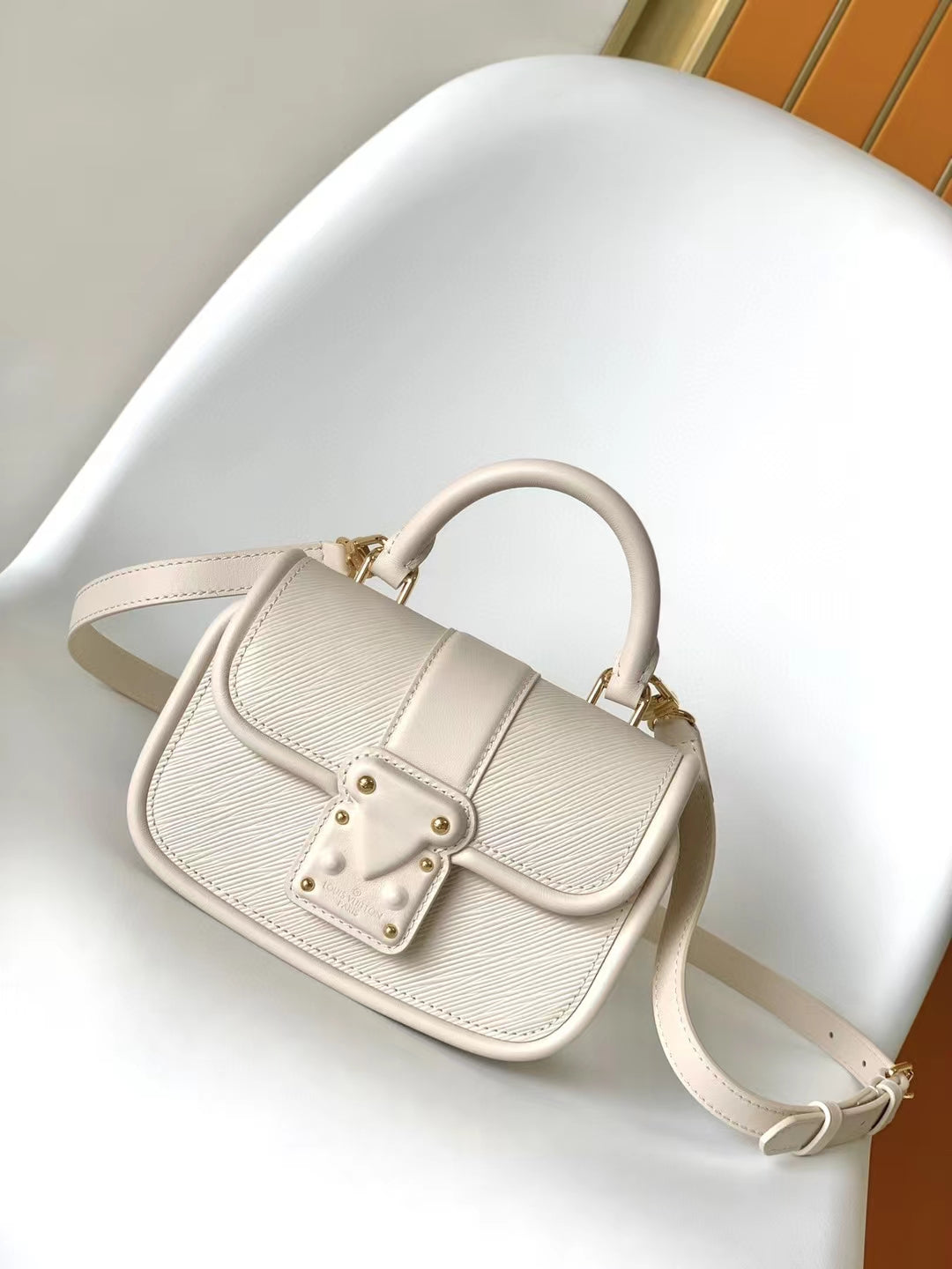 Louis Vuitton Elegant Beige Mini Top Handle Bag with Gold Lock Clasp