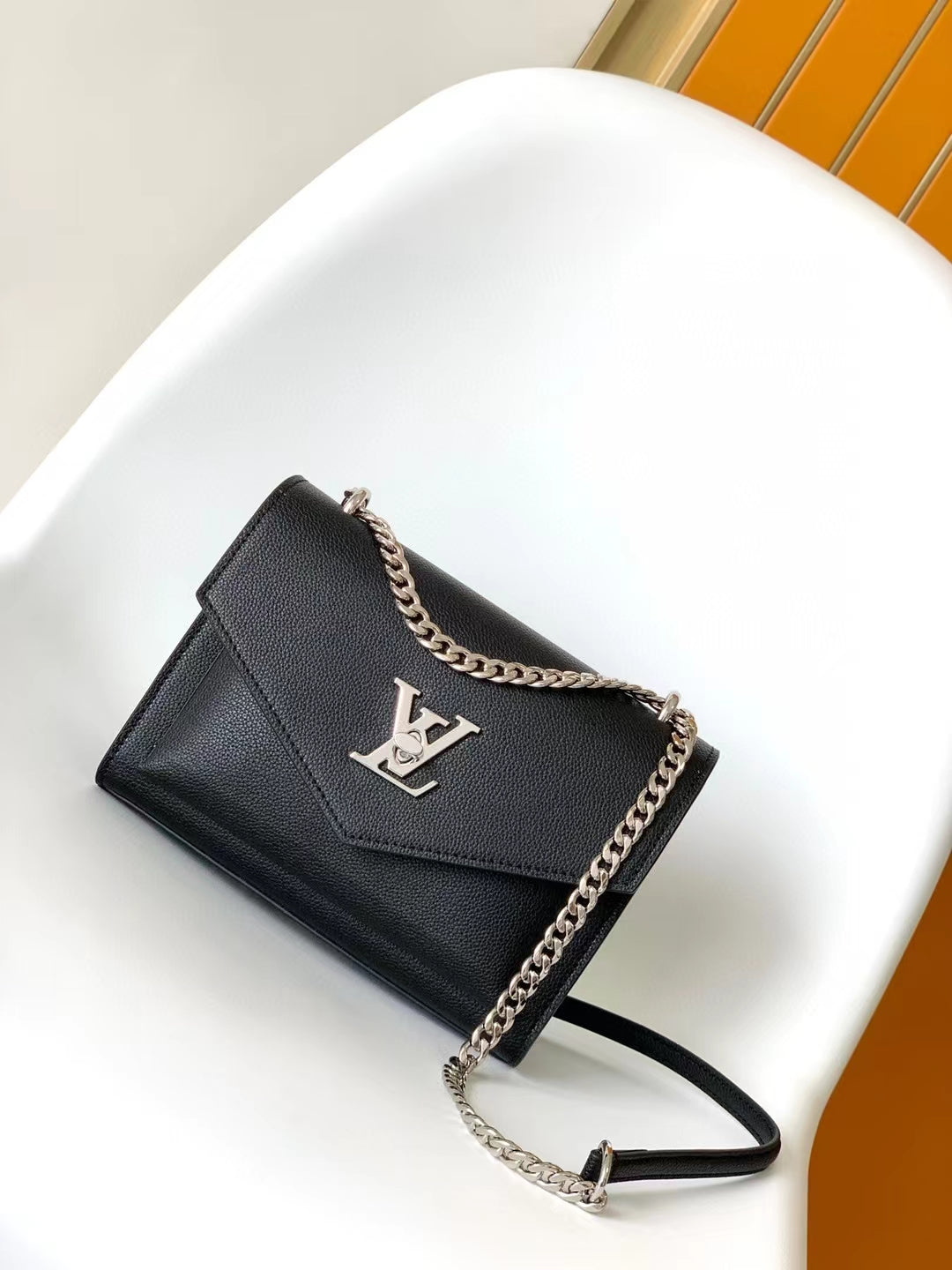 Louis Vuitton Elegant Black Leather Envelope Handbag with Silver Chain Strap