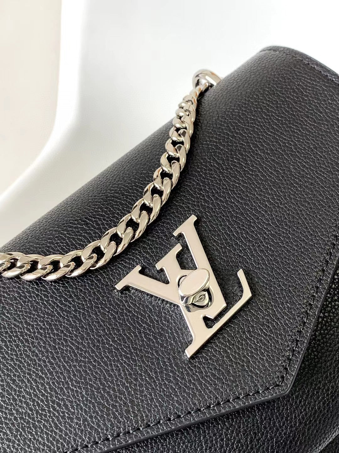 Louis Vuitton Elegant Black Leather Envelope Handbag with Silver Chain Strap
