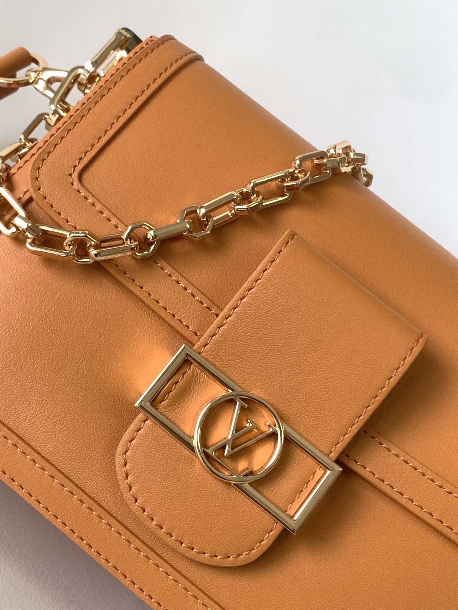 Women's Tan Leather Crossbody Handbag with Gold Chain Strap and Logo Buckle