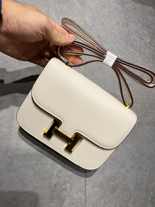 Elegant Cream Leather Crossbody Bag with Gold H Clasp