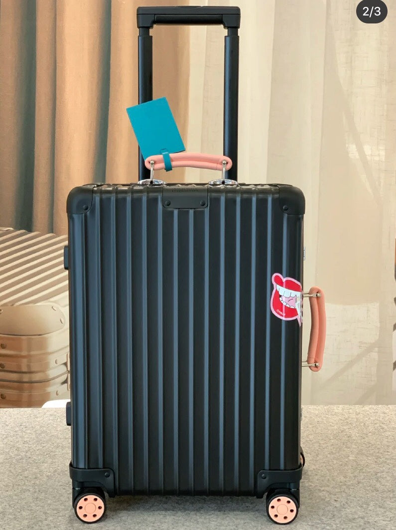 Matte Black Hardshell Spinner Suitcase with Orange Handles and Wheels