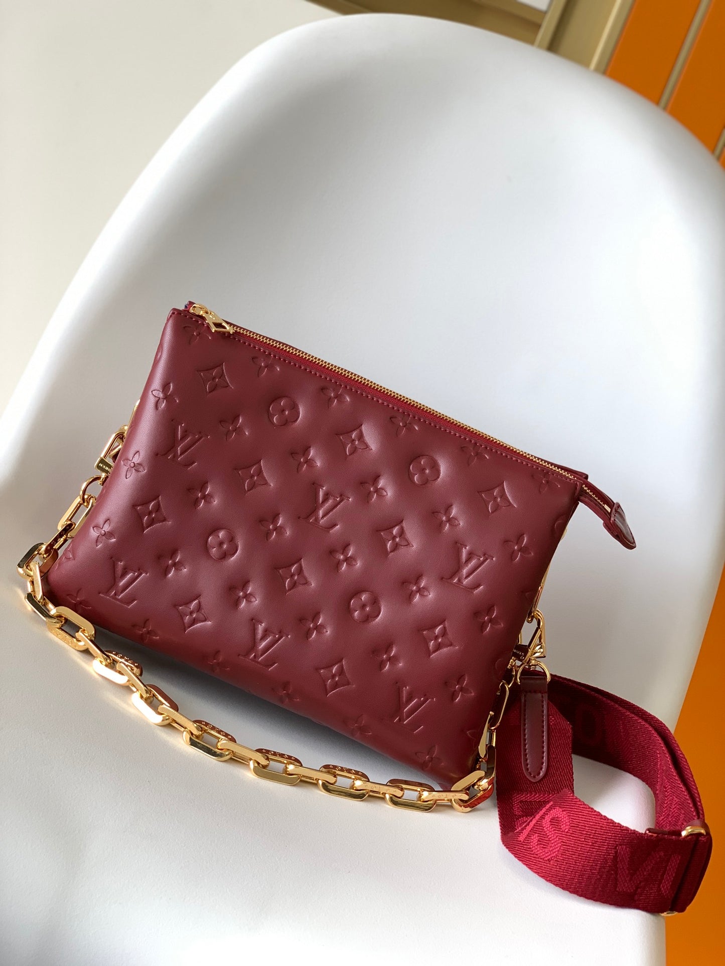 Louis Vuitton Elegant Burgundy Embossed Crossbody Bag with Wide Fabric Strap