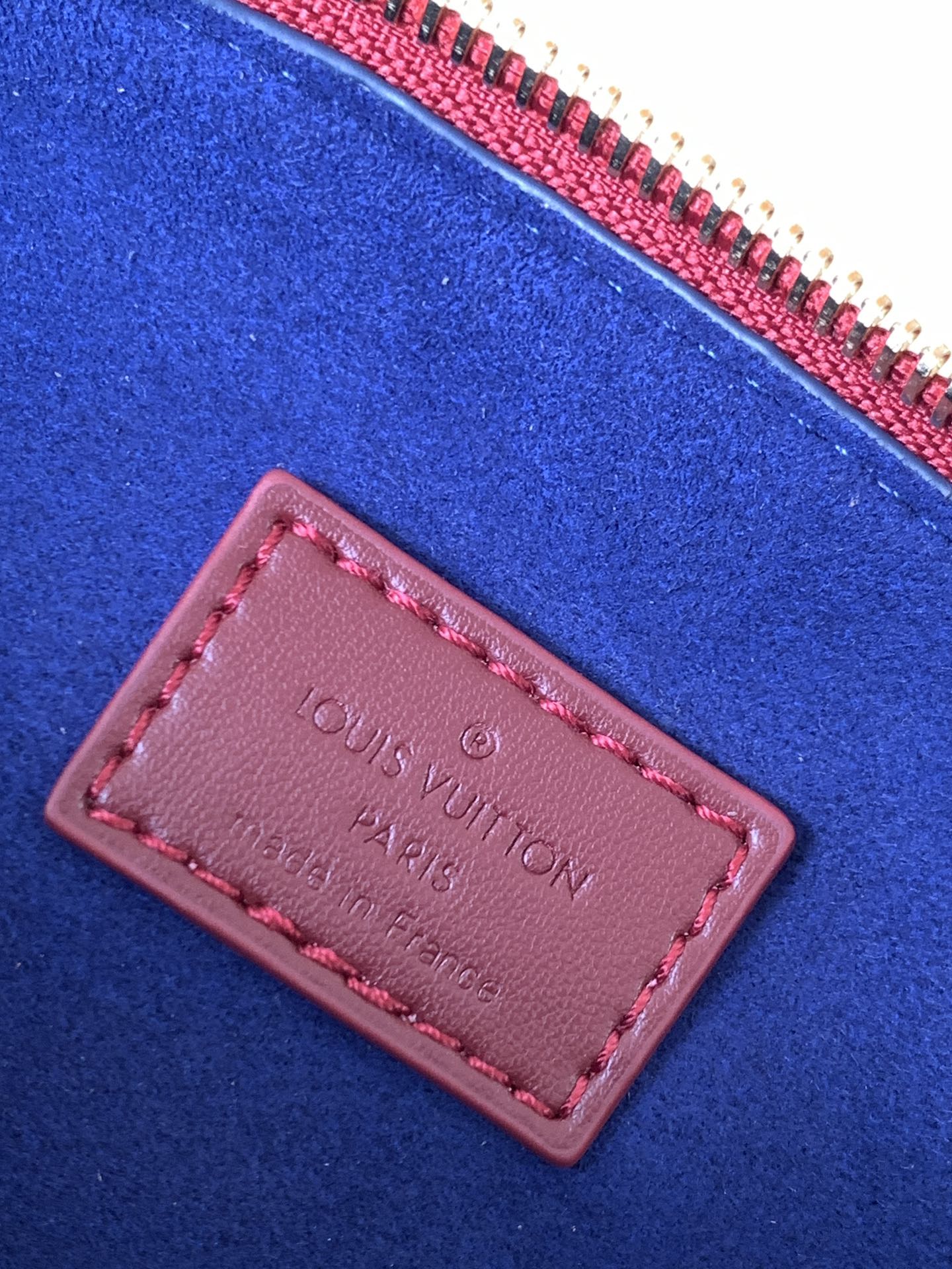 Louis Vuitton Elegant Burgundy Embossed Crossbody Bag with Wide Fabric Strap