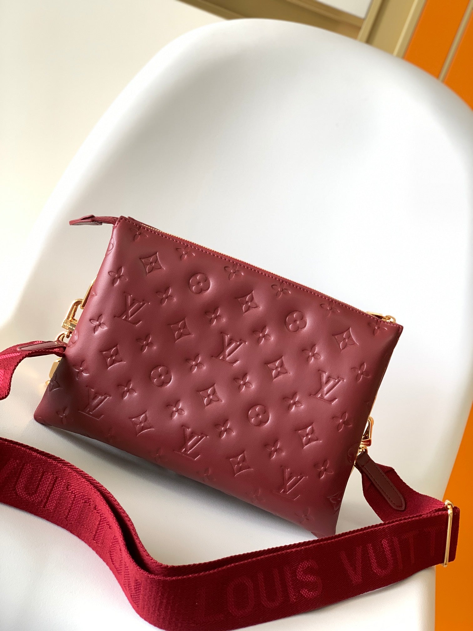 Louis Vuitton Elegant Burgundy Embossed Crossbody Bag with Wide Fabric Strap