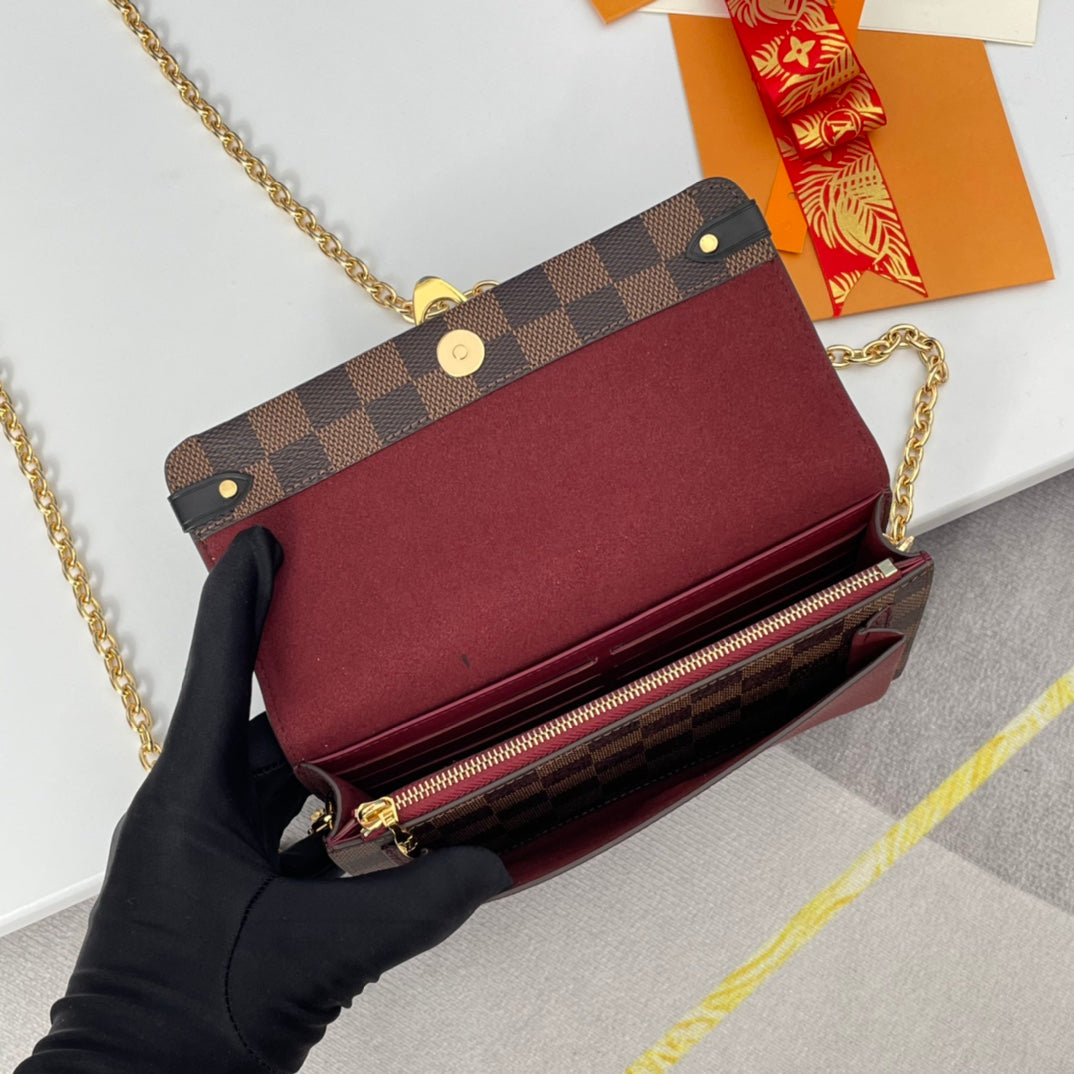 Louis Vuitton Brown Checkered Crossbody Bag with Gold Chain and Red Accent