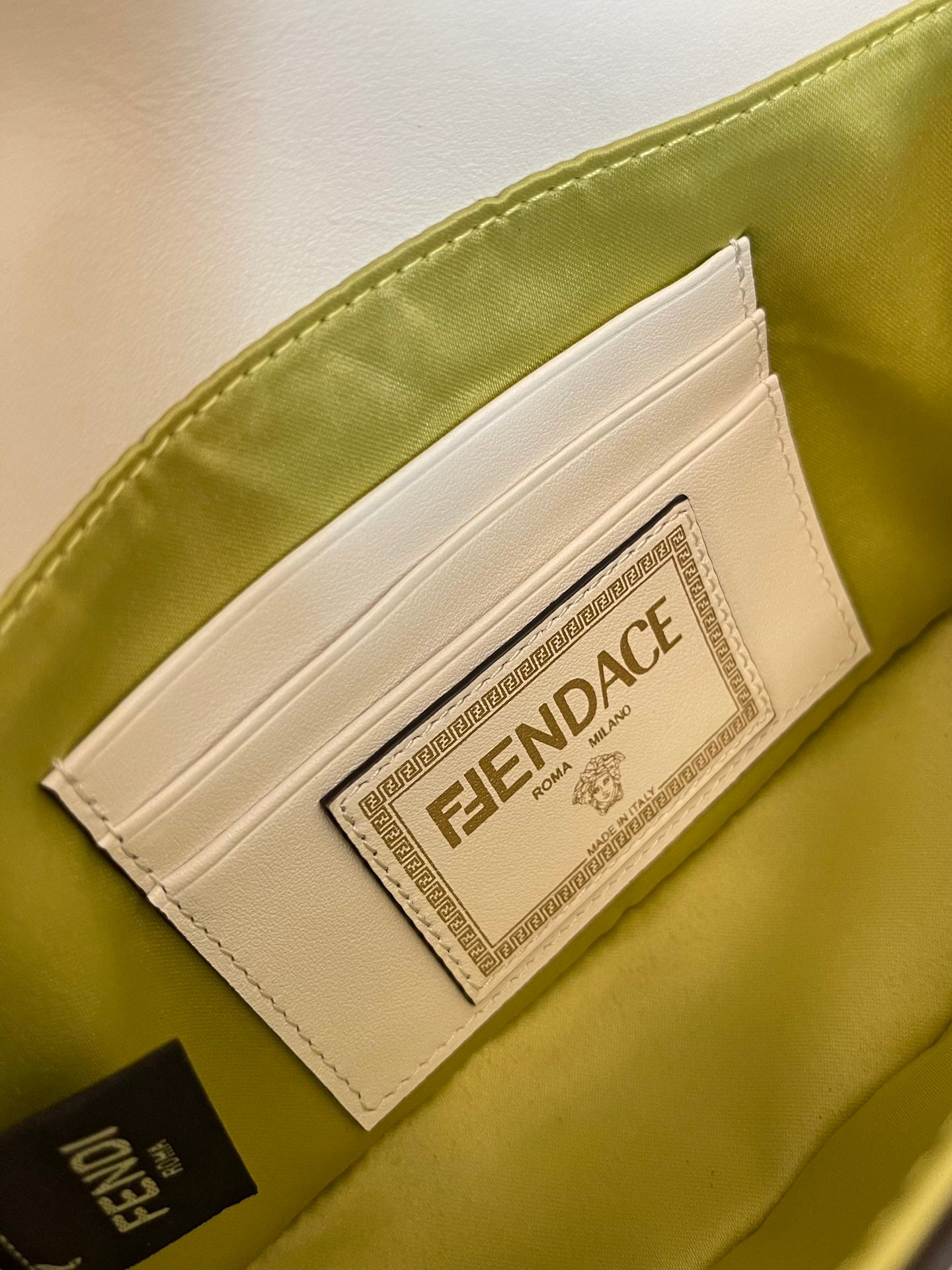 Elegant White Leather Mini Bag with Gold Flower Safety Pin Details