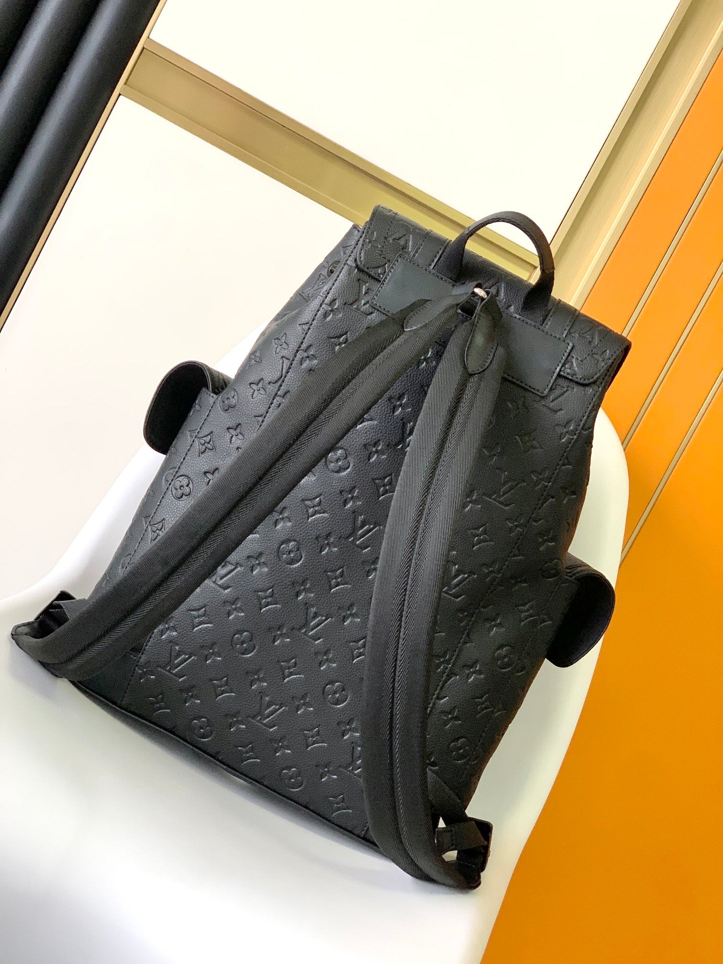 Louis Vuitton Luxury Black Embossed Leather Backpack with Side Pockets