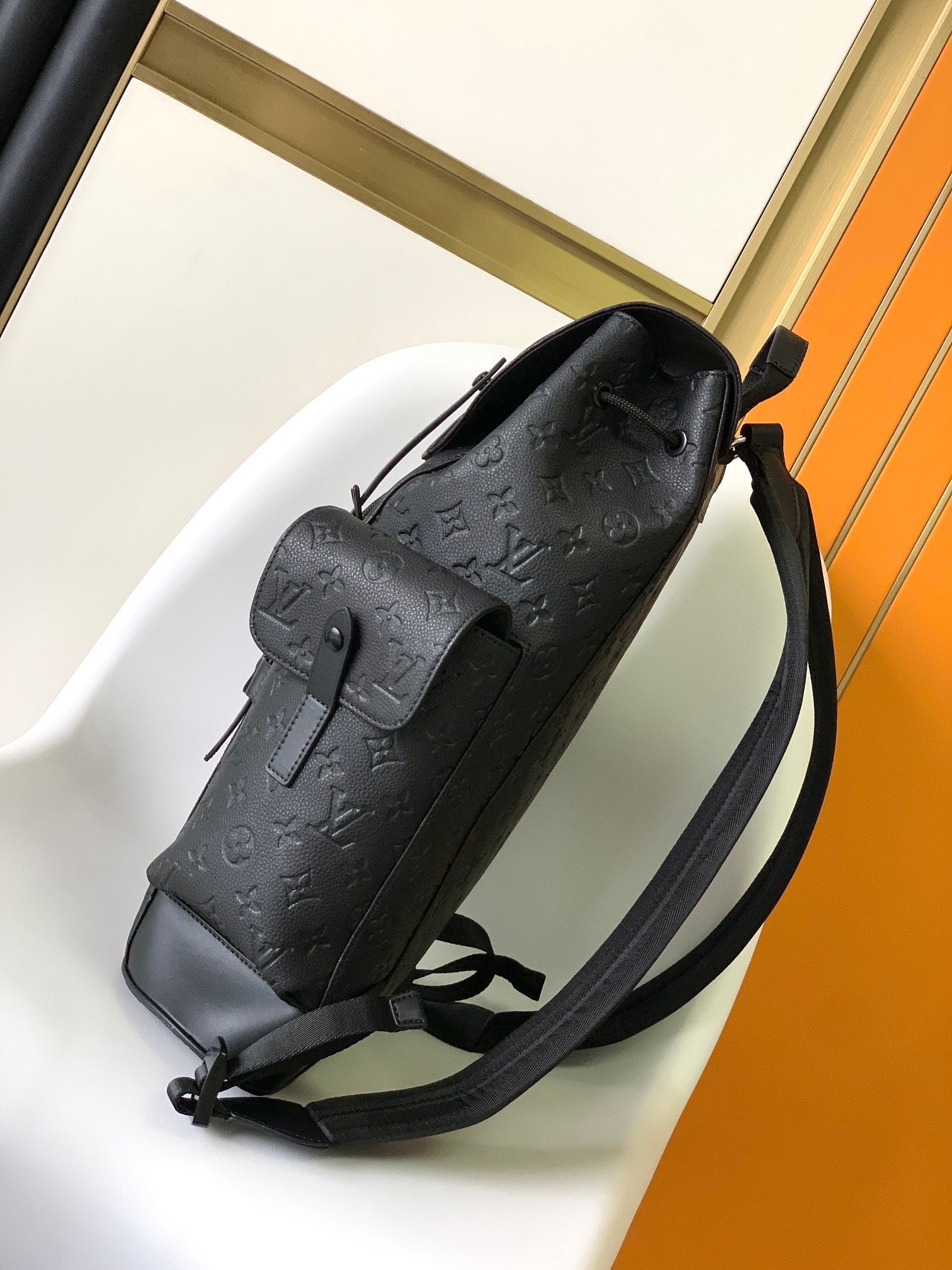 Louis Vuitton Luxury Black Embossed Leather Backpack with Side Pockets