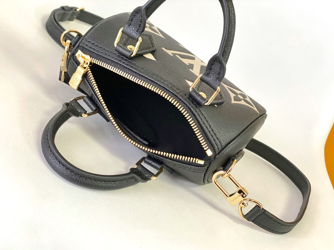 Louis Vuitton Elegant Black Mini Barrel Handbag with Gold Monogram Motifs