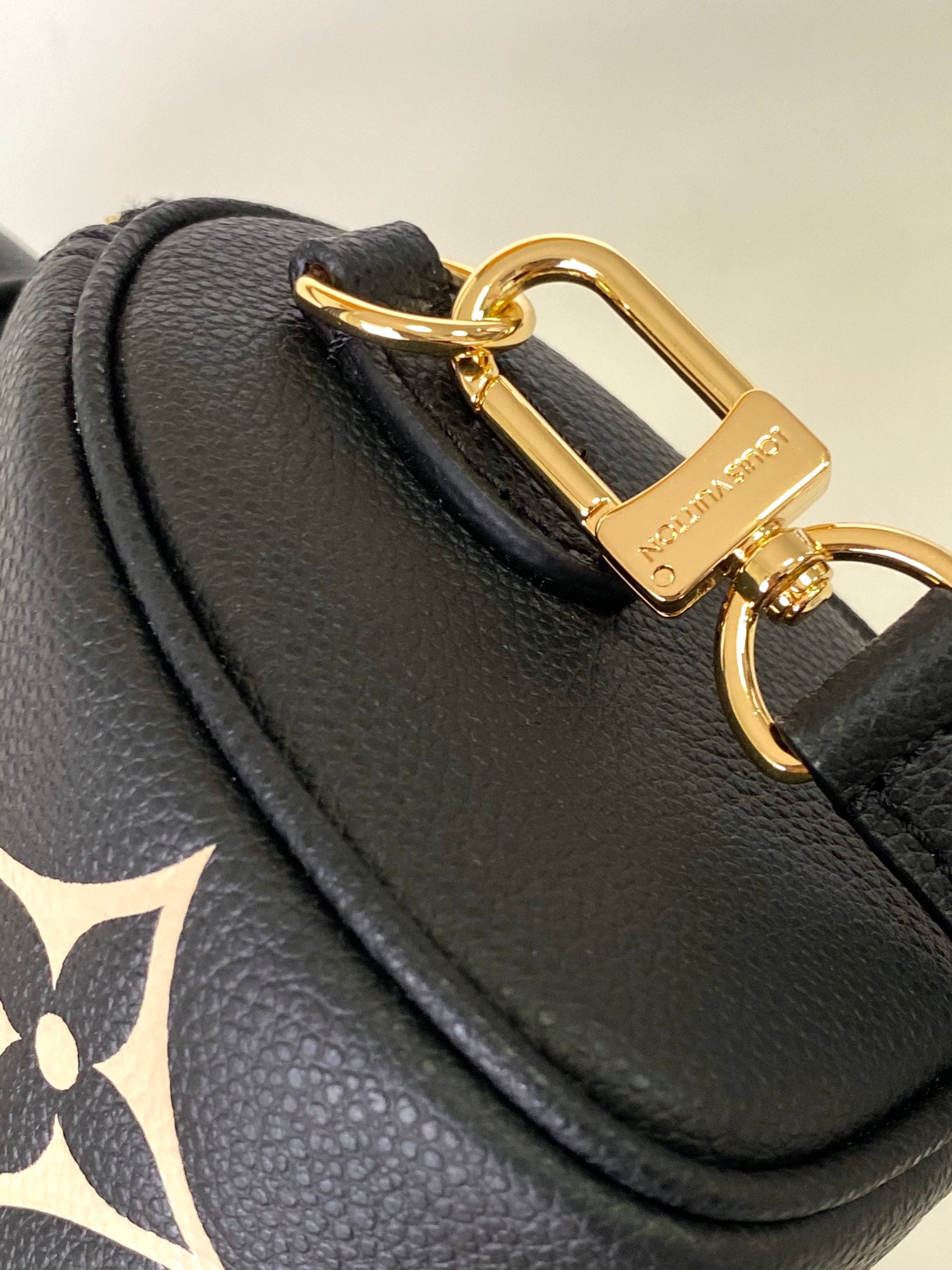 Louis Vuitton Elegant Black Mini Barrel Handbag with Gold Monogram Motifs