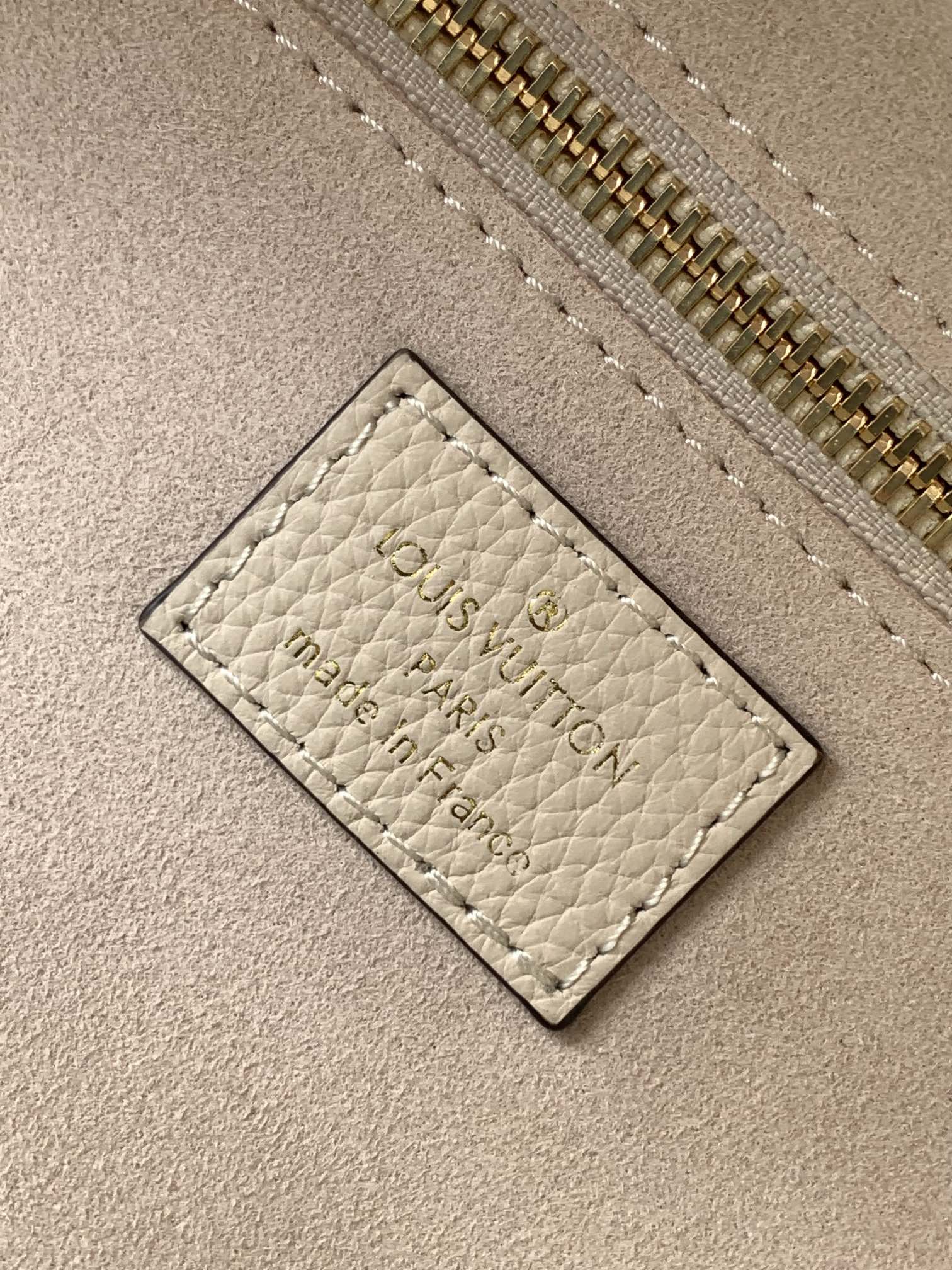 Louis Vuitton Elegant Beige Embossed Leather Tote Bag with Side Drawstrings