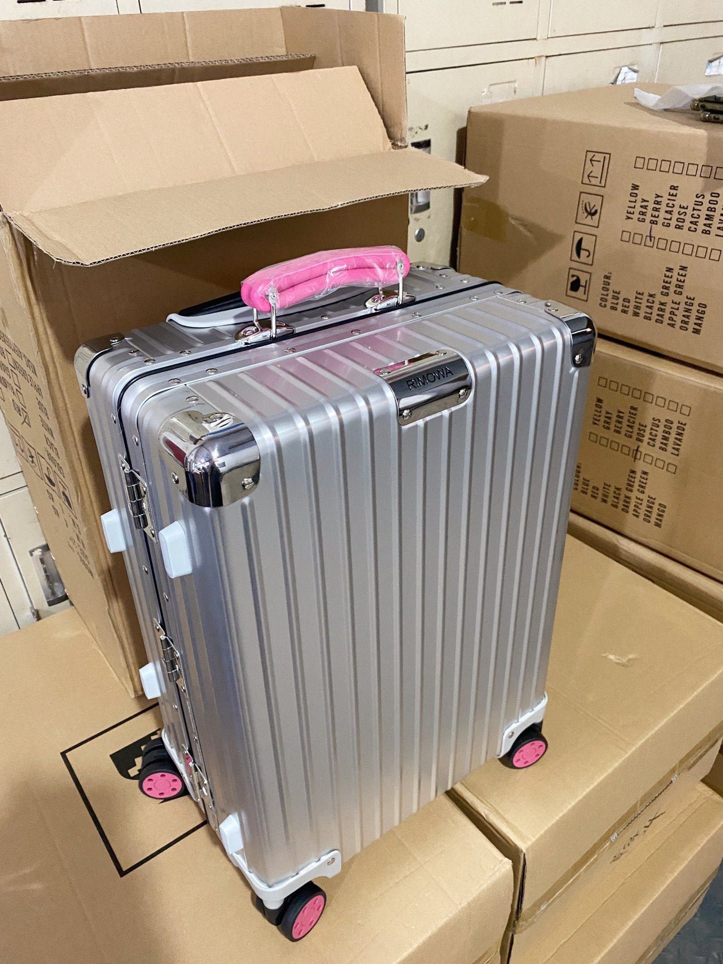Silver Hardside Spinner Luggage with Pink Wheels and Handle