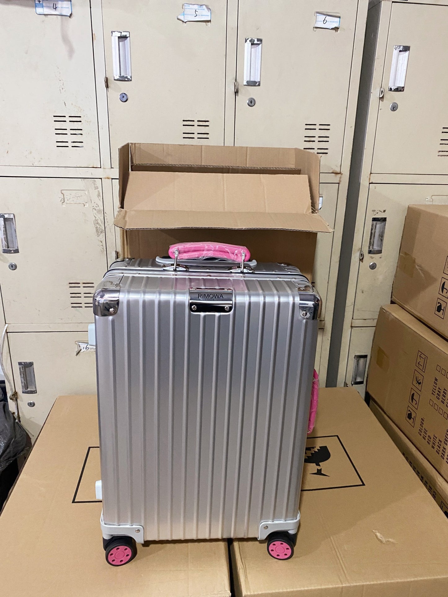 Silver Hardside Spinner Luggage with Pink Wheels and Handle