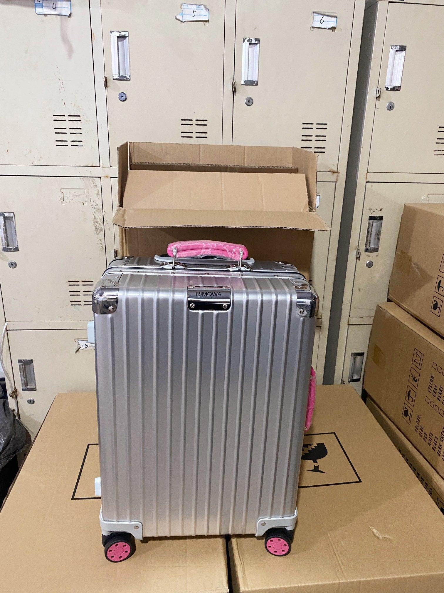 Silver Hardside Spinner Luggage with Pink Wheels and Handle