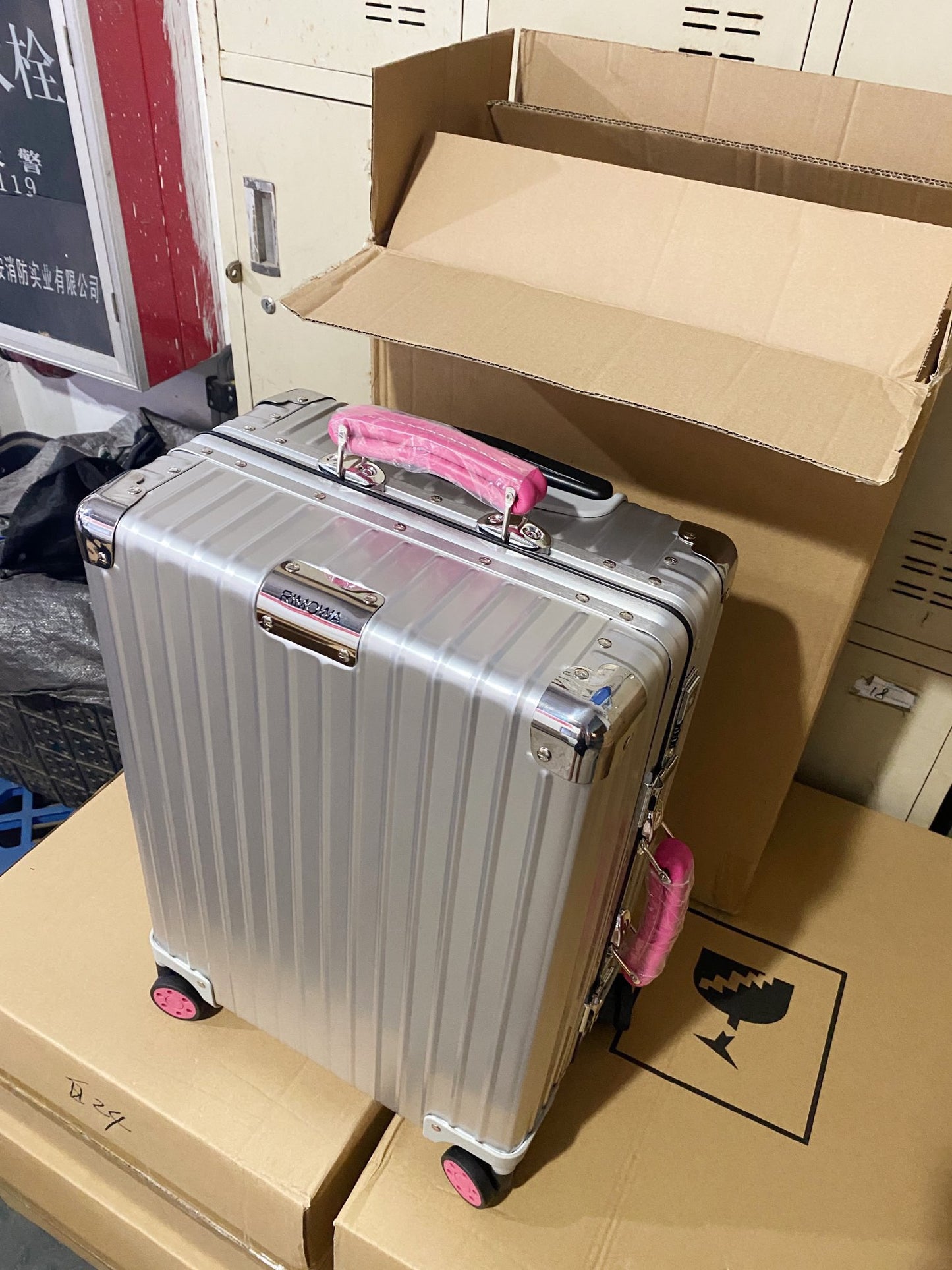 Silver Hardside Spinner Luggage with Pink Wheels and Handle