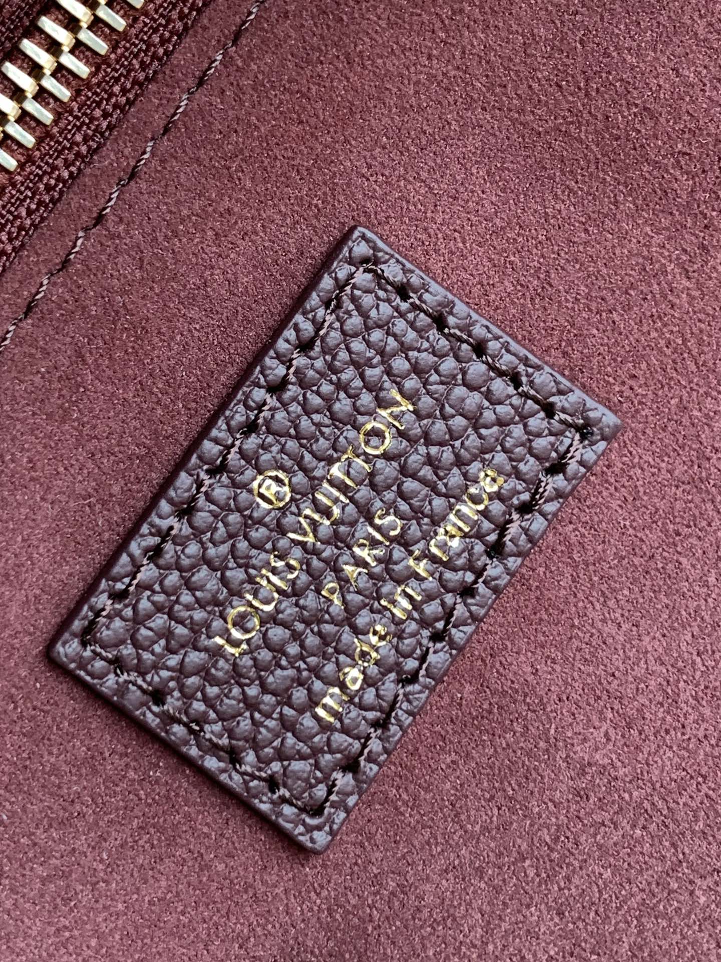 Louis Vuitton Elegant Burgundy Embossed Leather Tote Bag with Side Drawstrings