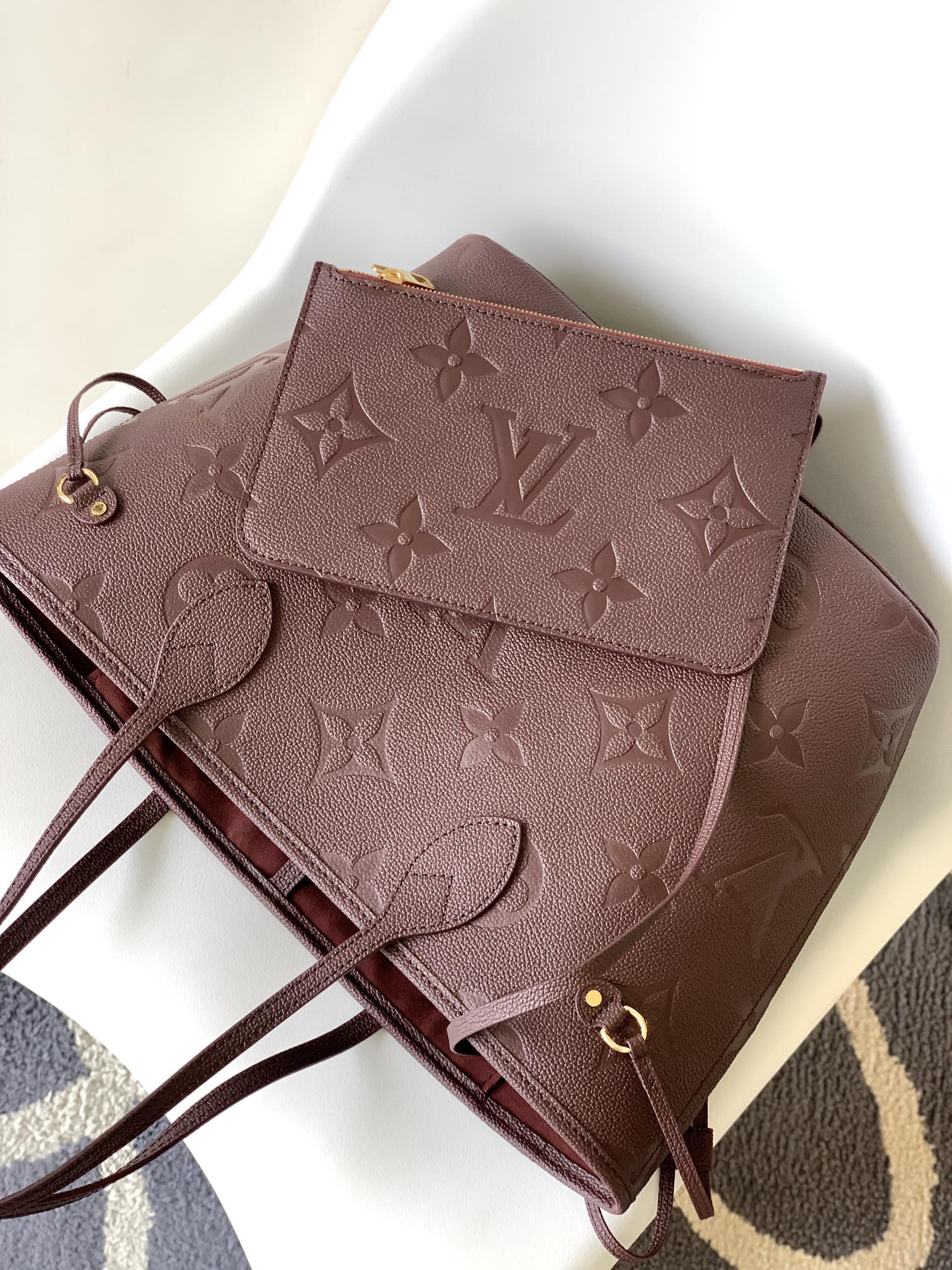 Louis Vuitton Elegant Burgundy Embossed Leather Tote Bag with Side Drawstrings