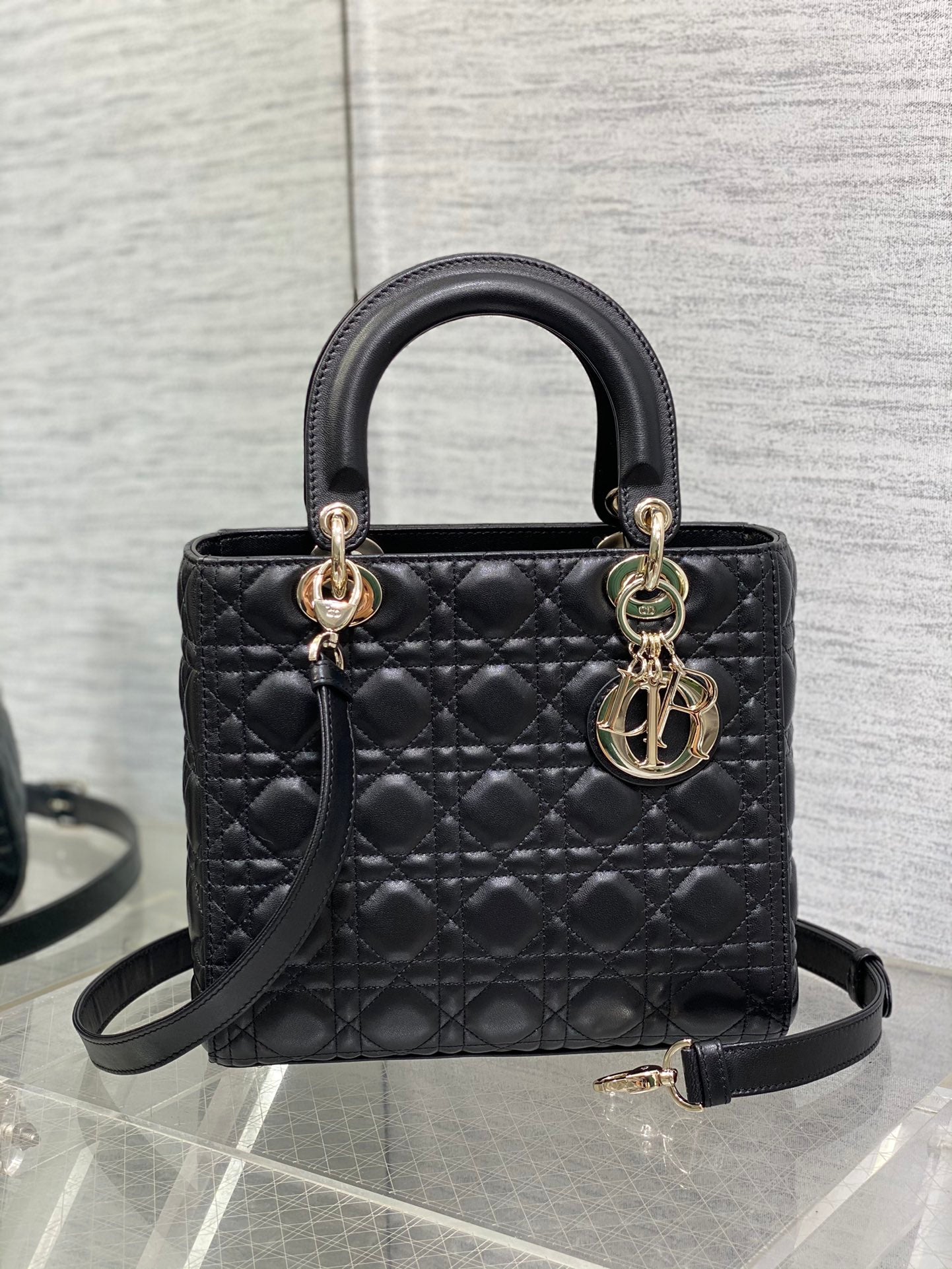 Dior Elegant Black Quilted Leather Handbag with Top Handle and Gold Charms