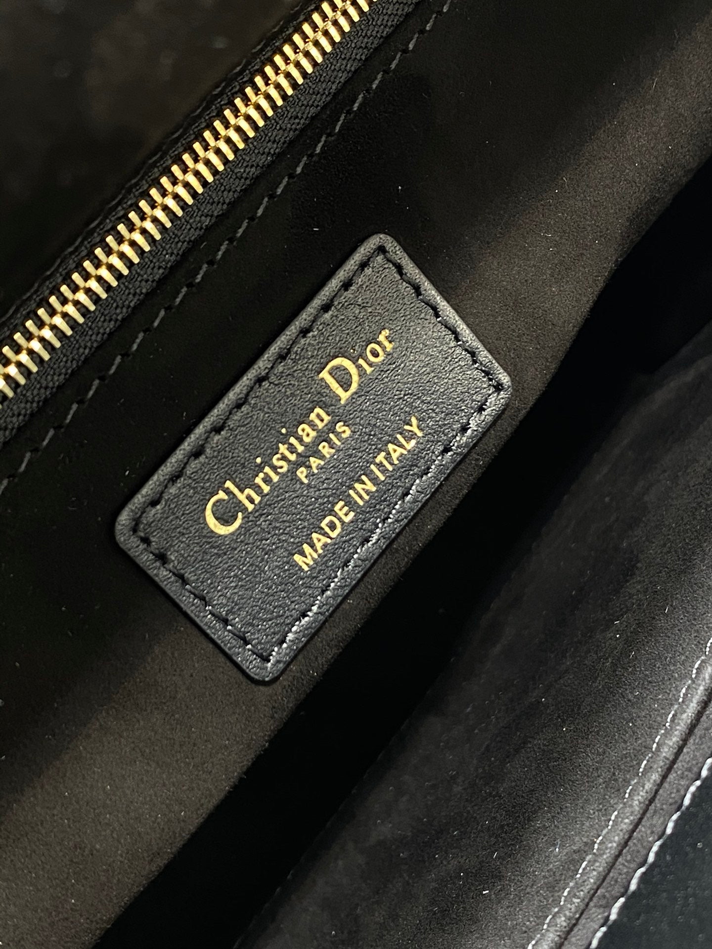Dior Elegant Black Quilted Leather Handbag with Top Handle and Gold Charms
