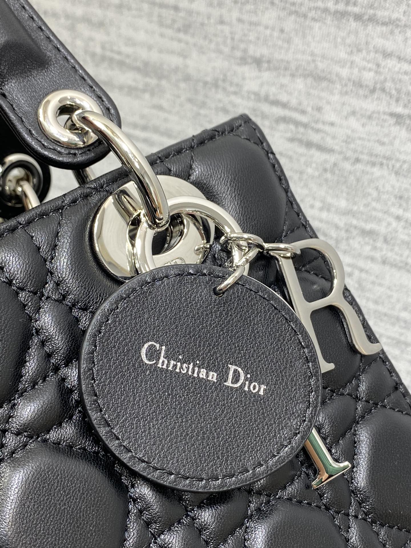 Dior Elegant Black Quilted Leather Handbag with Top Handles and Strap