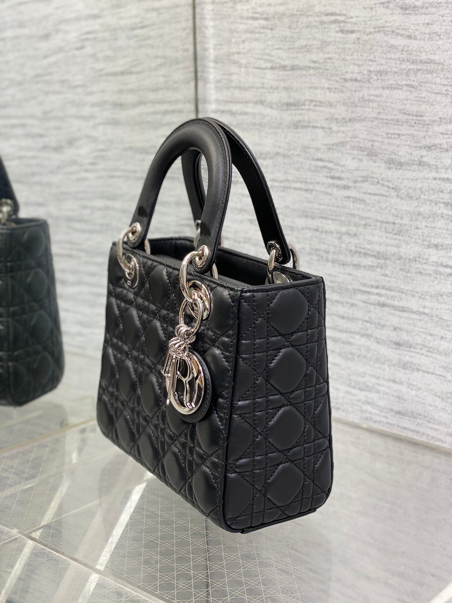 Dior Elegant Black Quilted Leather Handbag with Top Handles and Strap