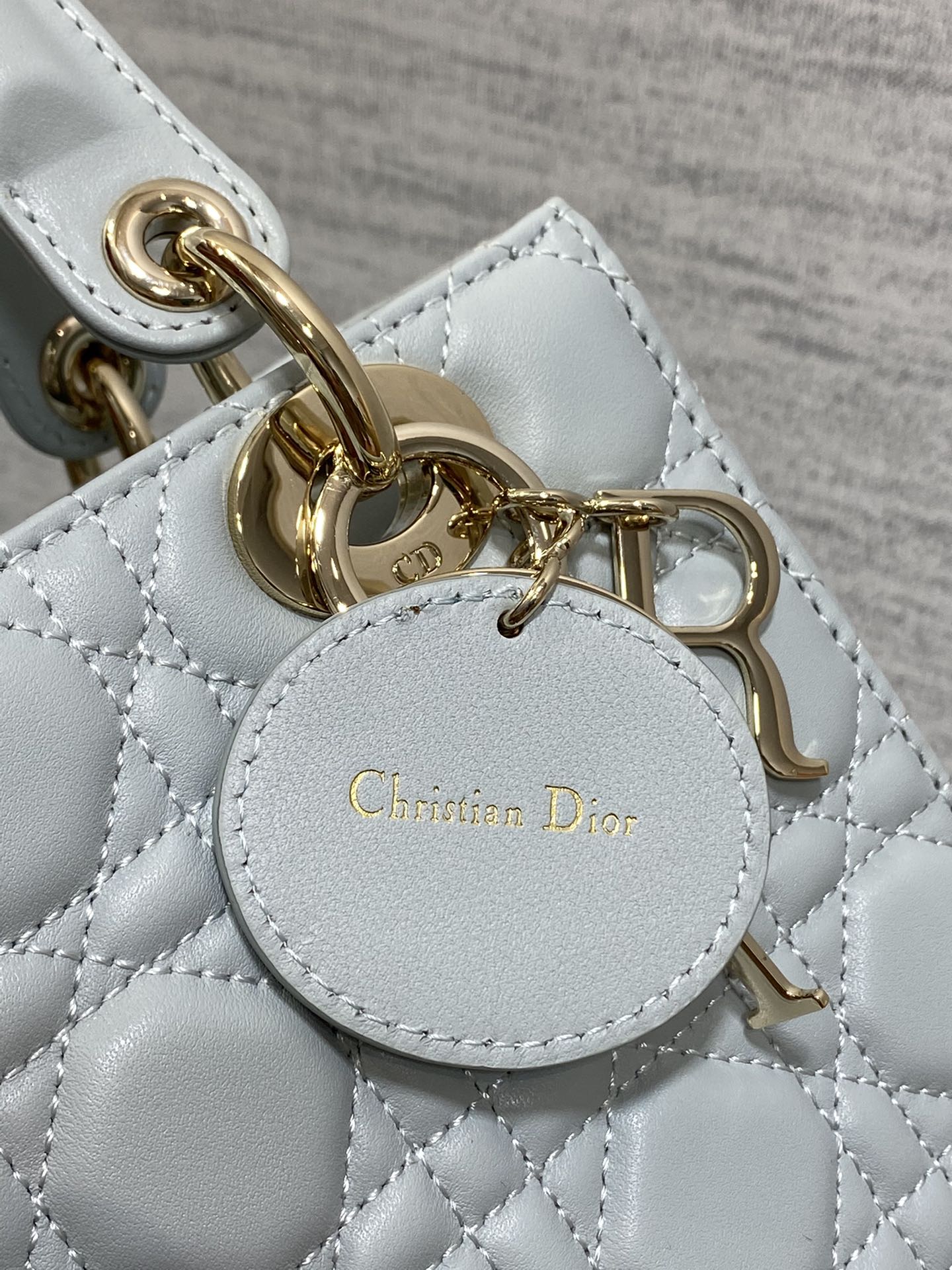Dior Light Blue Quilted Leather Handbag with Gold Charms and Strap