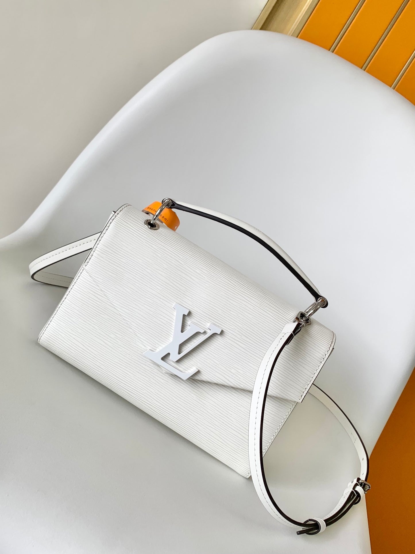Louis Vuitton Elegant White Textured Leather Handbag with Top Handle and Strap