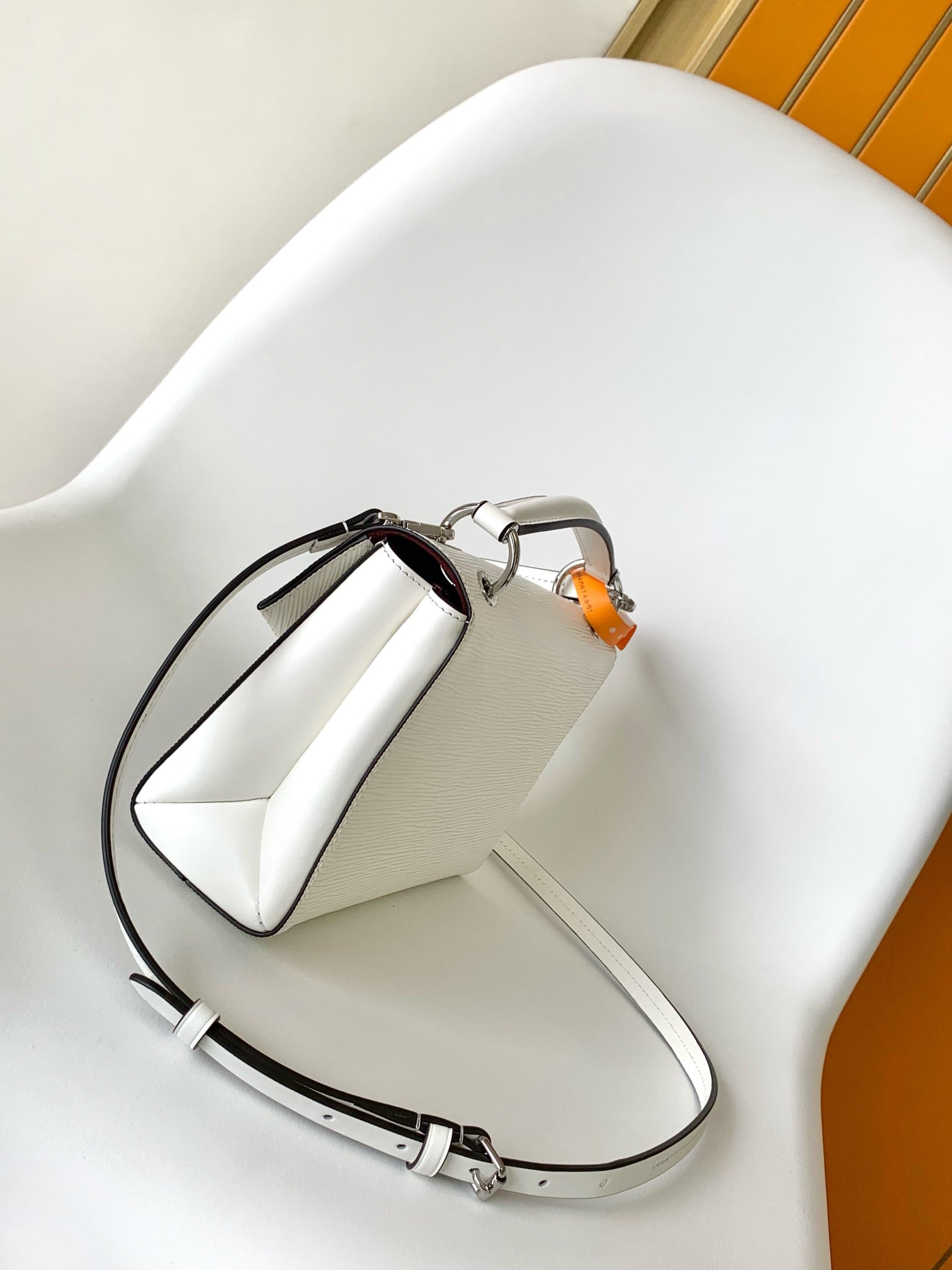 Louis Vuitton Elegant White Textured Leather Handbag with Top Handle and Strap