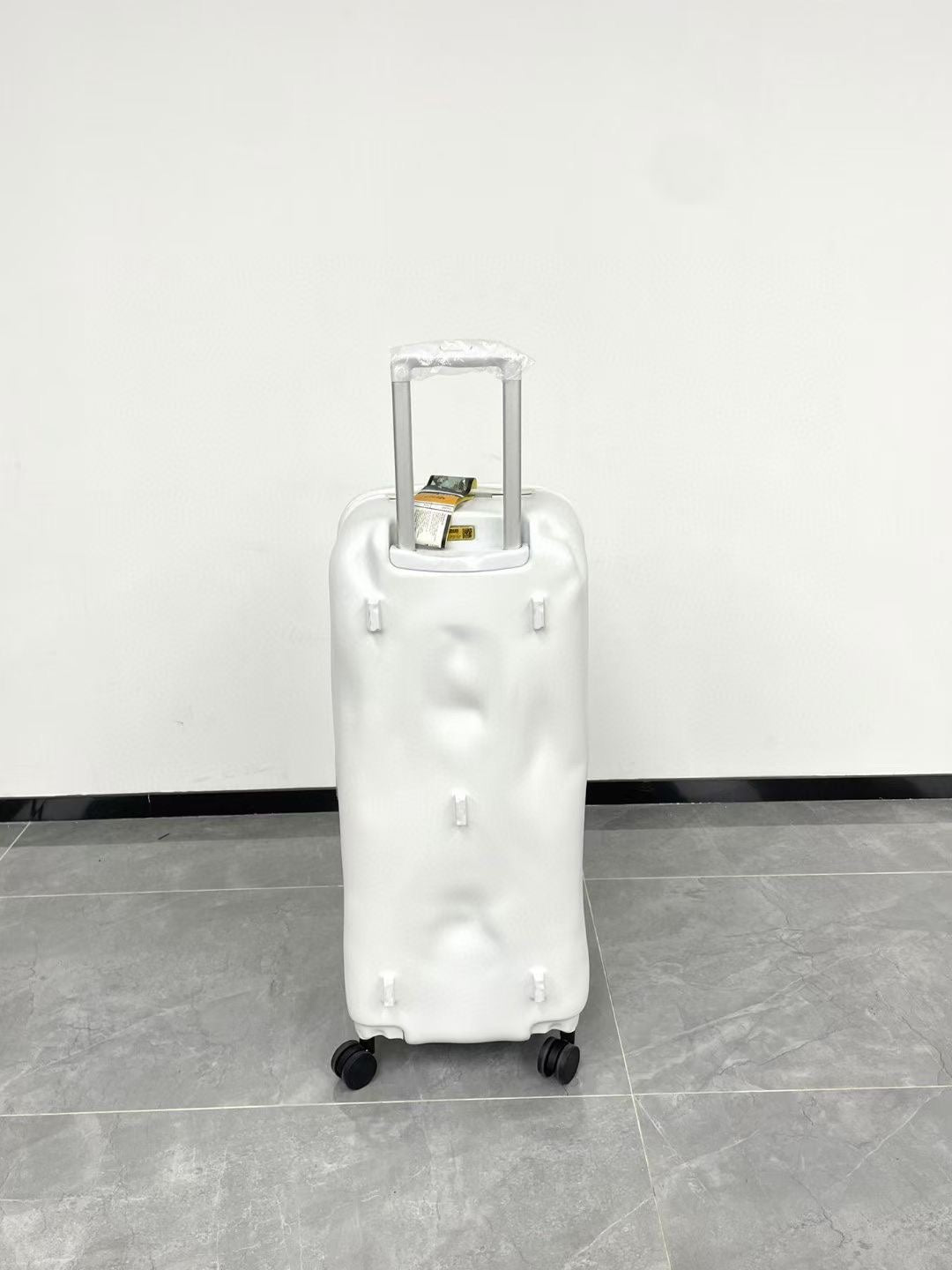 Modern Glossy White Dented Hardshell Spinner Suitcase