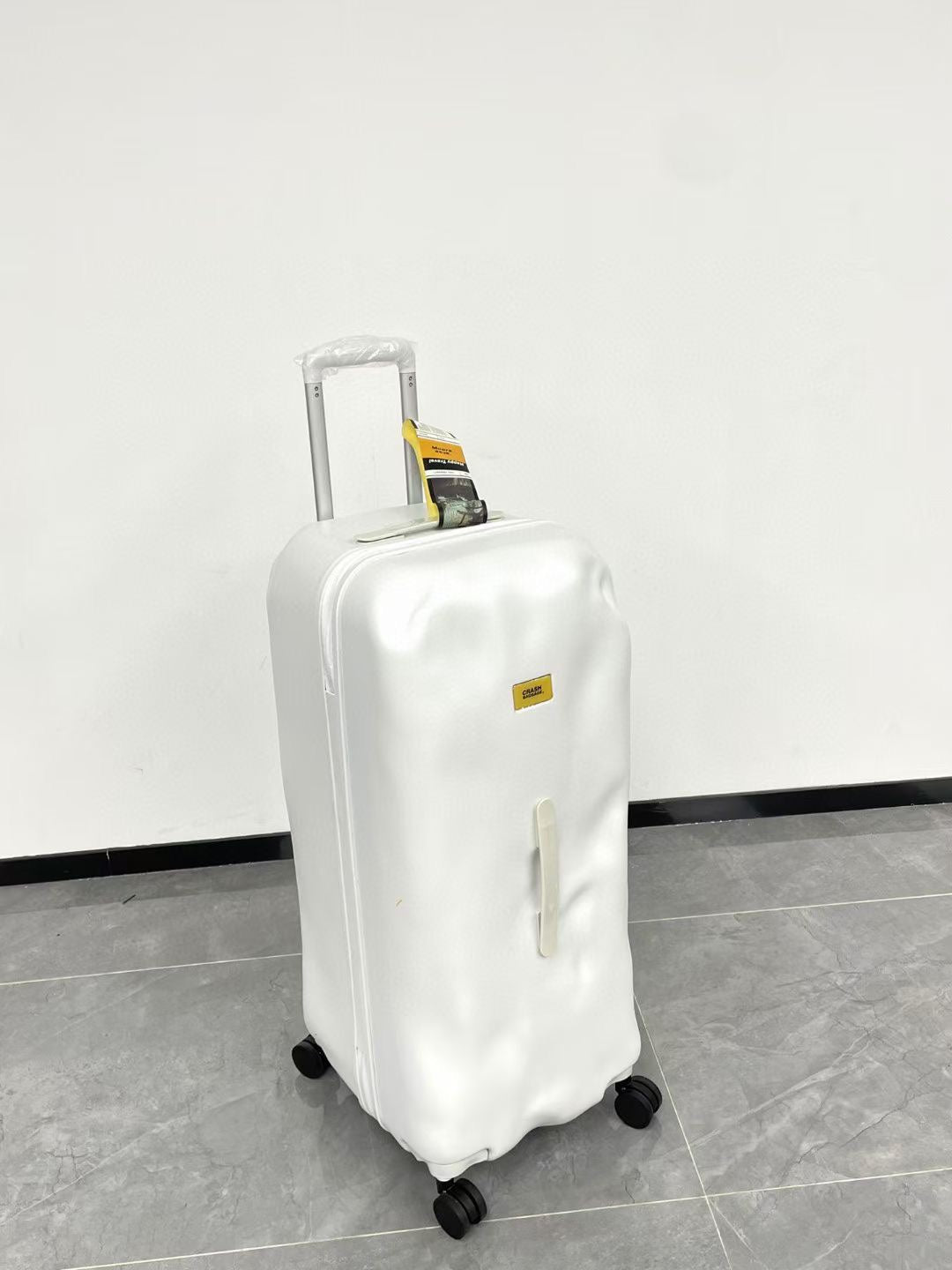 Modern Glossy White Dented Hardshell Spinner Suitcase