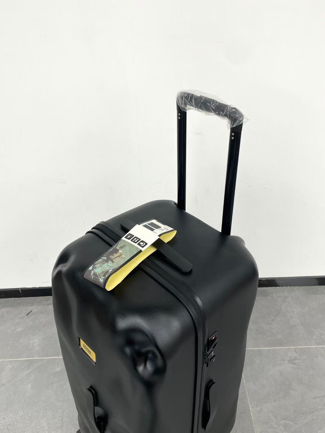 Black Spinner Carry-On Luggage with Yellow Accent Strap
