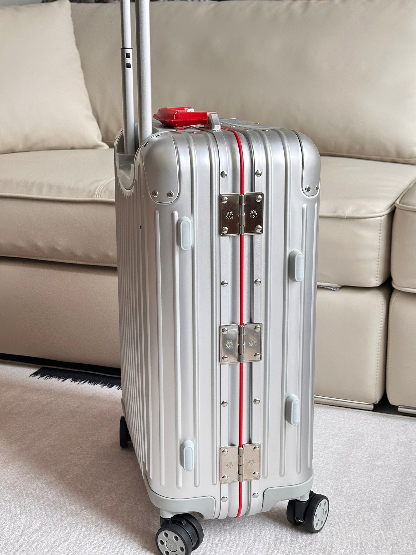 Silver Ribbed Hardside Spinner Suitcase with Red Accent Handle