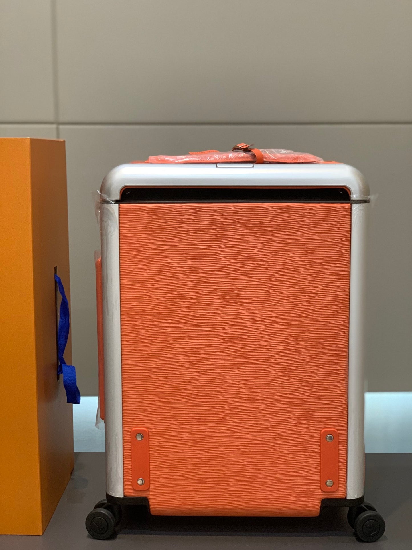 Orange Textured Leather Rolling Suitcase Luxury Carry-On Spinner Luggage