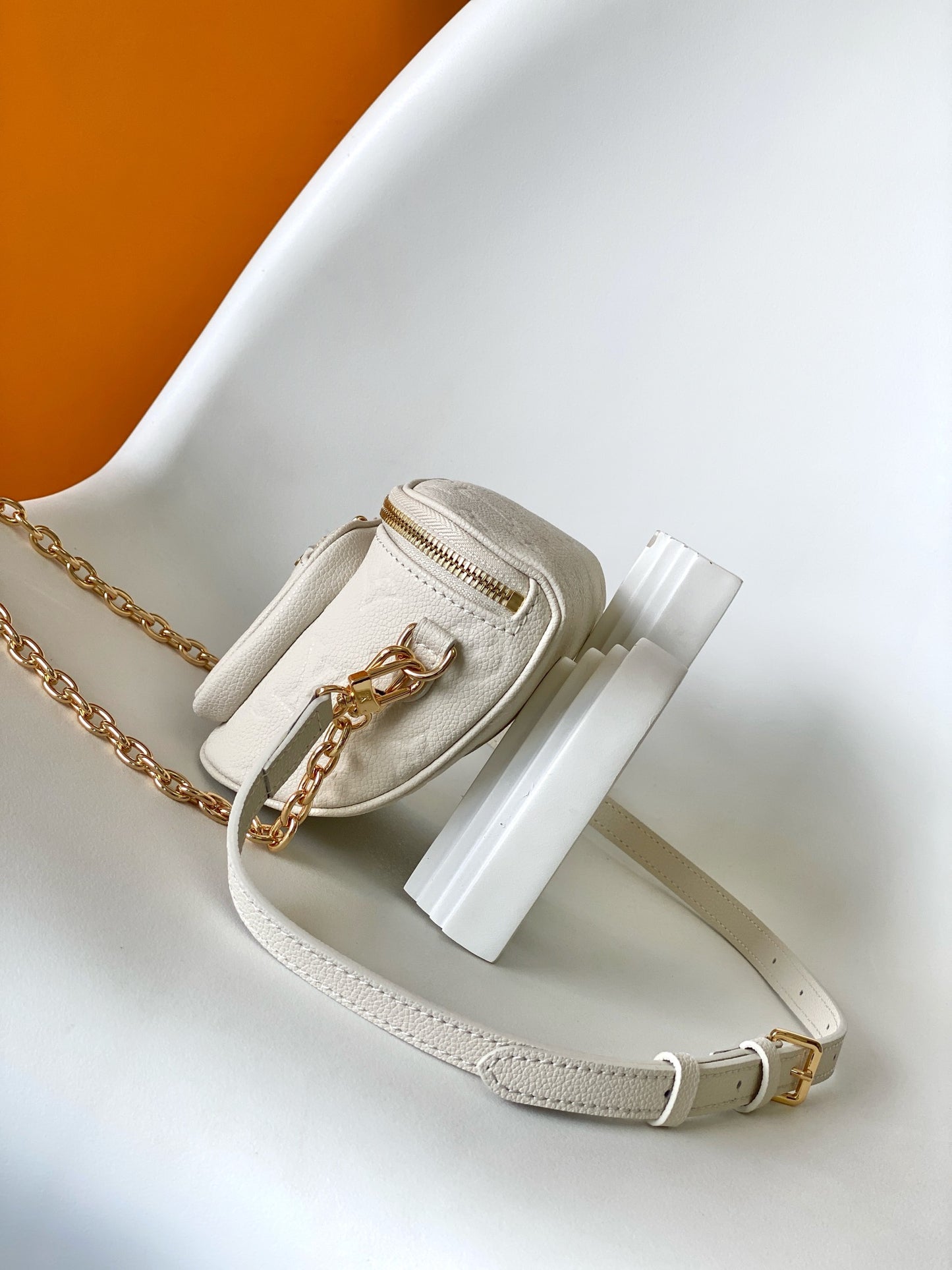 Louis Vuitton Elegant Cream Embossed Leather Crossbody Bag with Gold Chain