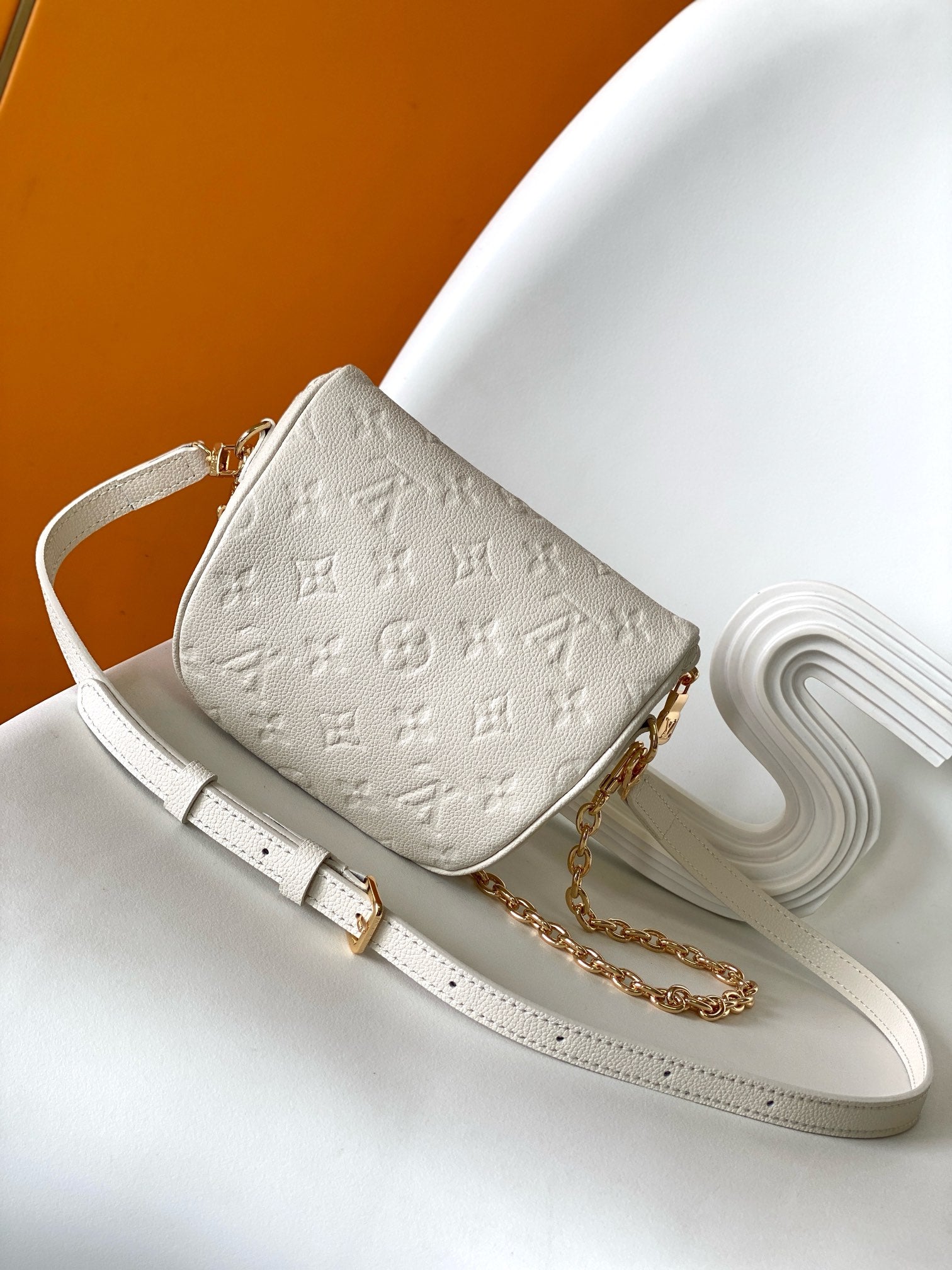 Louis Vuitton Elegant Cream Embossed Leather Crossbody Bag with Gold Chain