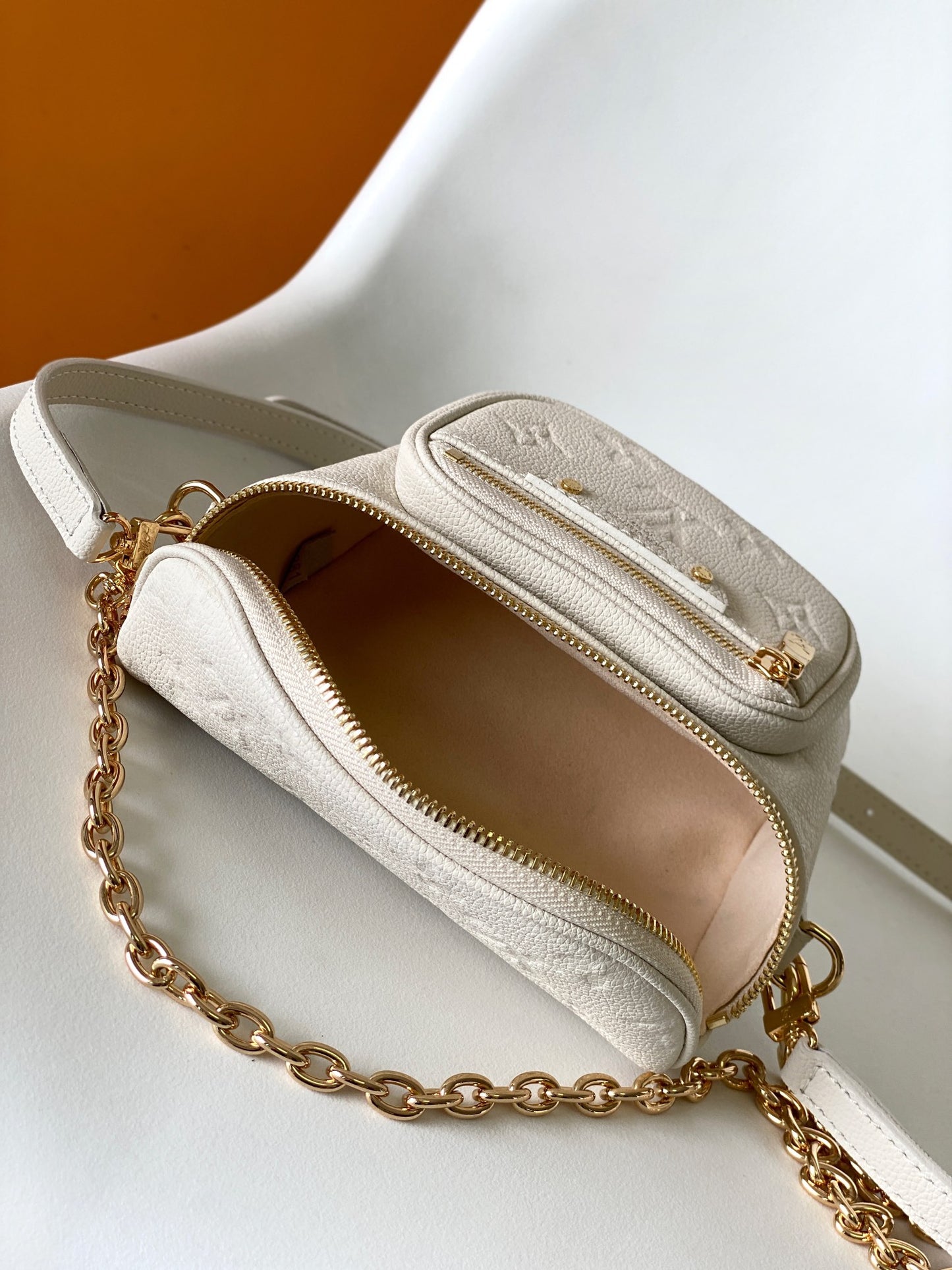 Louis Vuitton Elegant Cream Embossed Leather Crossbody Bag with Gold Chain
