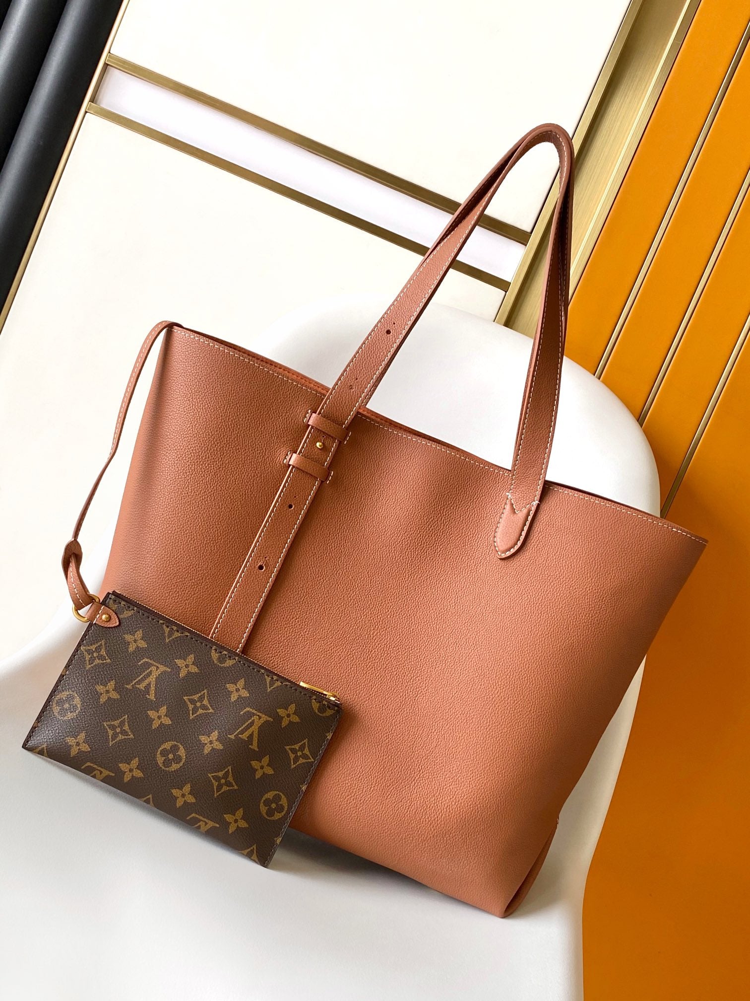 Louis Vuitton Classic Brown Leather Tote Bag with Gold Lock Accent and Shoulder Straps