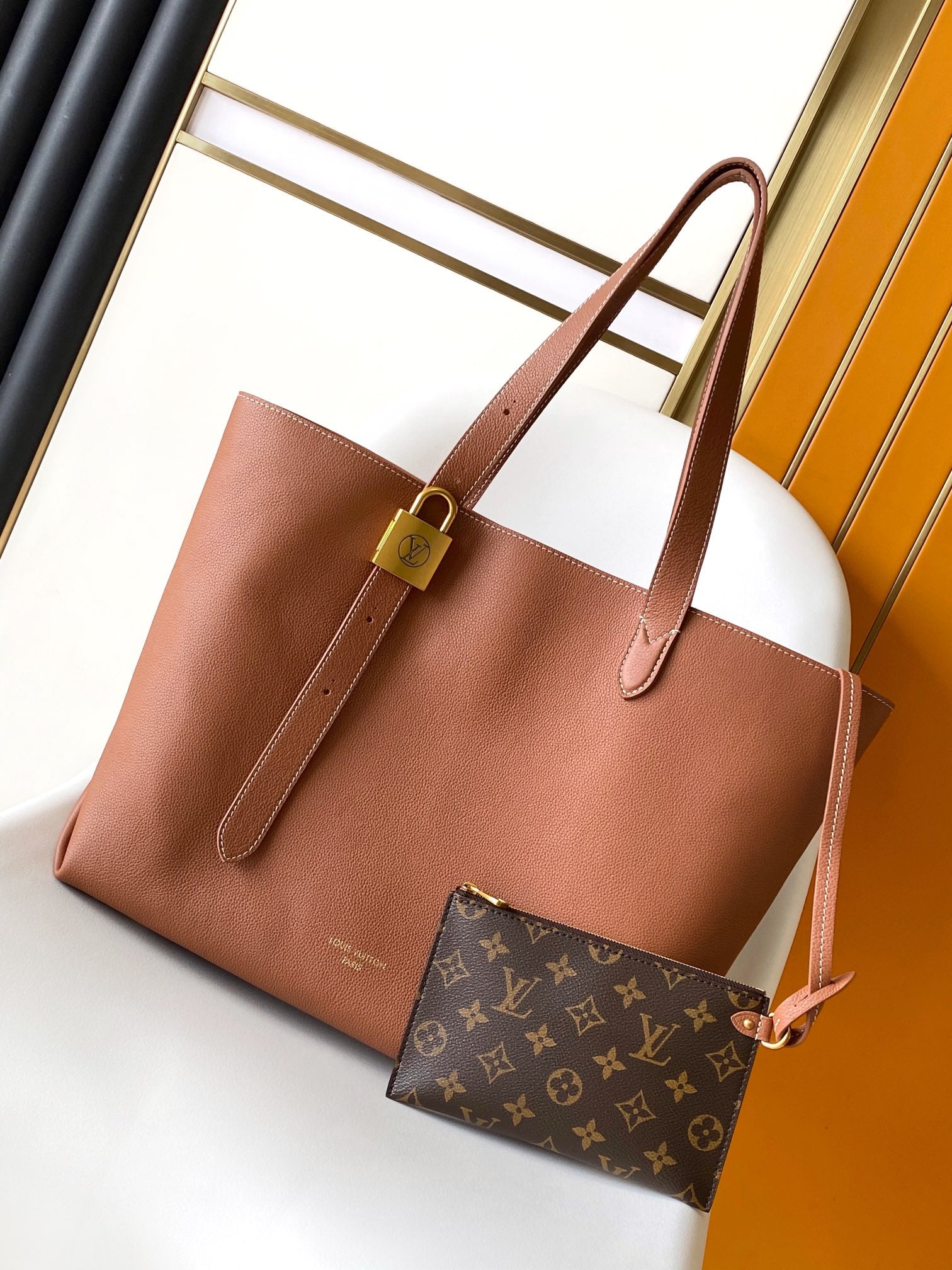 Louis Vuitton Classic Brown Leather Tote Bag with Gold Lock Accent and Shoulder Straps