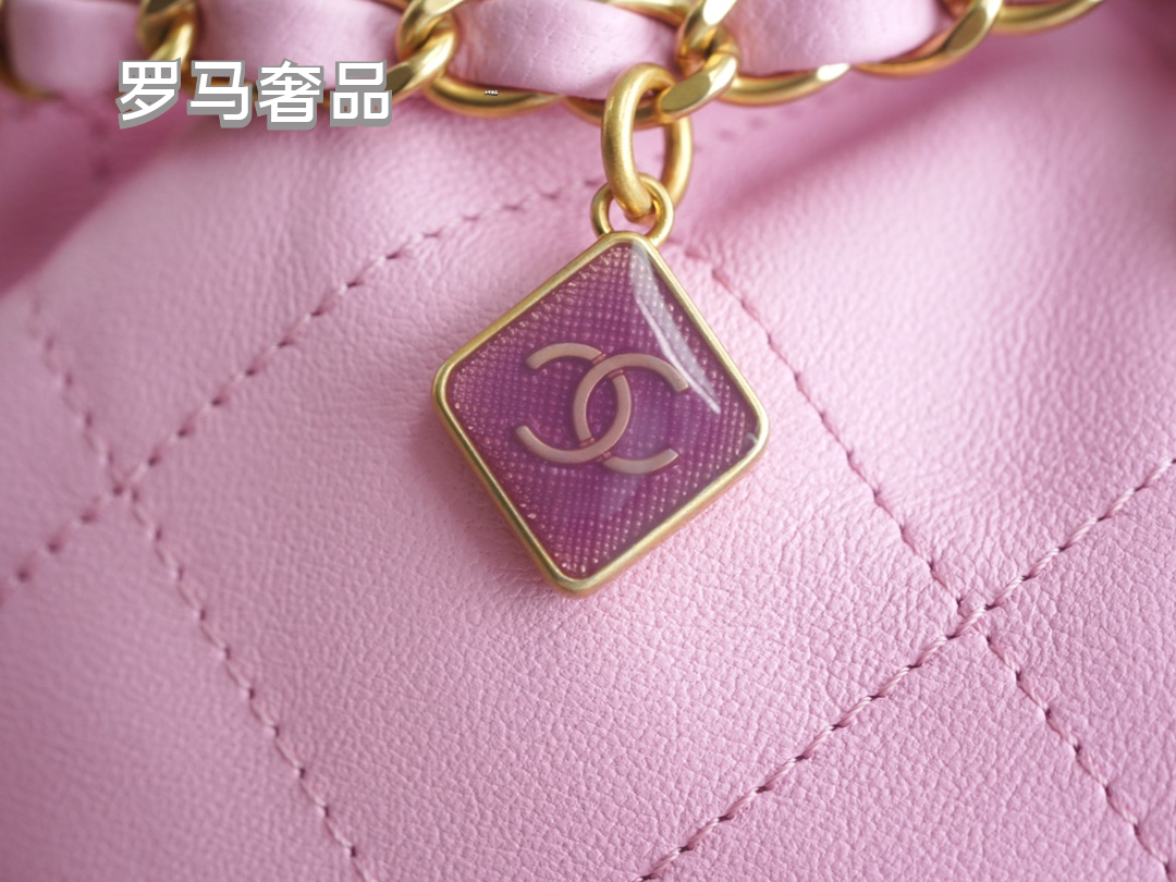 Pink Quilted Leather Bucket Bag with Gold-Tone Chain and Decorative Charms