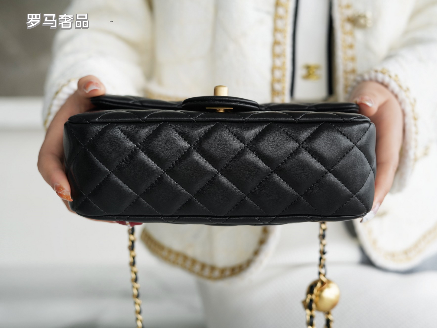 Luxury Quilted Black Leather Mini Flap Bag with Gold-Tone Chain and Ball Detail