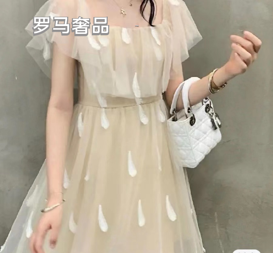 Elegant White Quilted Mini Handbag with Top Handle and Gold-Tone Charms